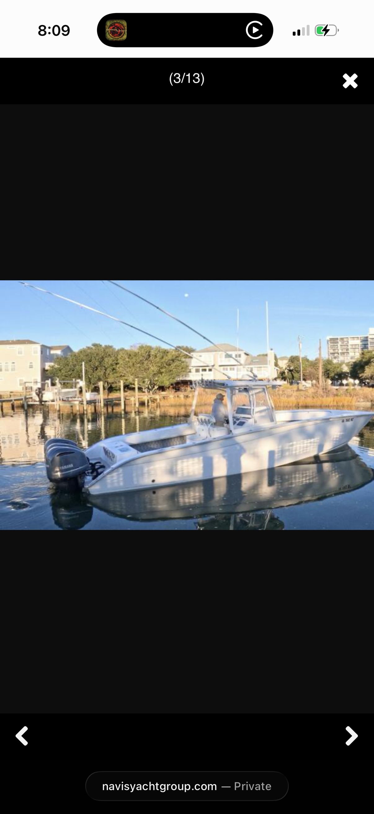 A 2007 Cape Horn 36T boat is on the water, surrounded by buildings and trees.