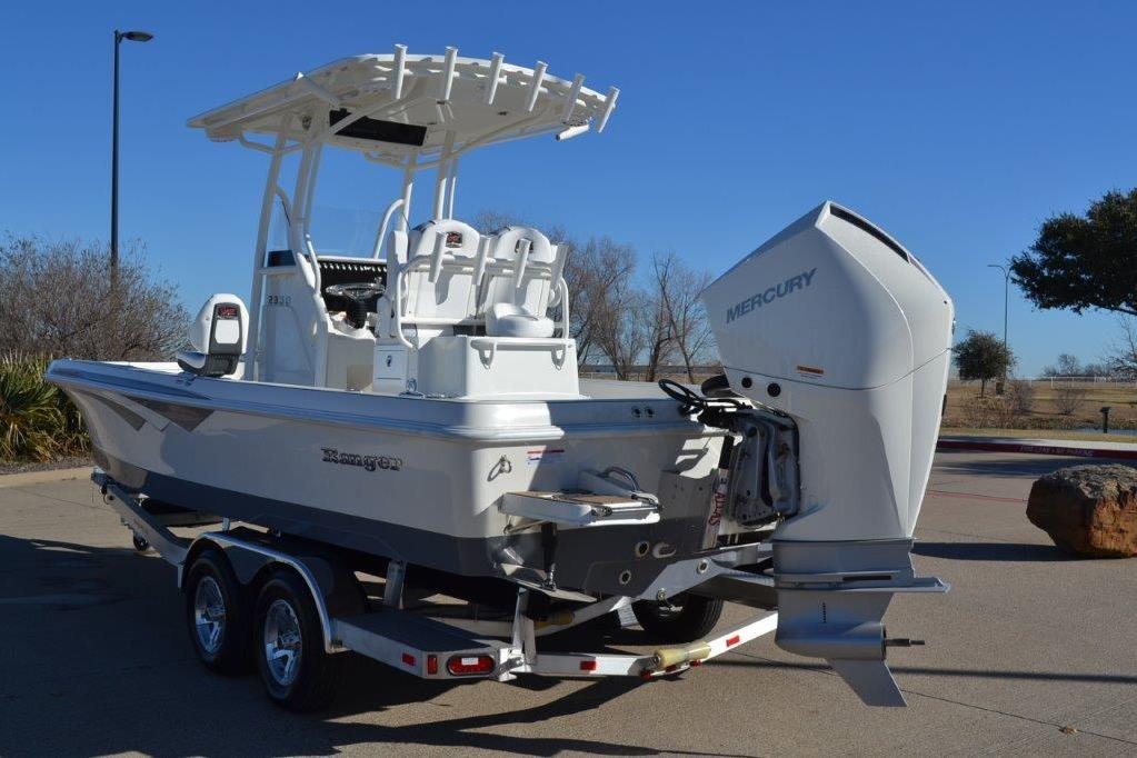 2025 Ranger 2360 Bay boat with Mercury engine on trailer, parked outdoors.