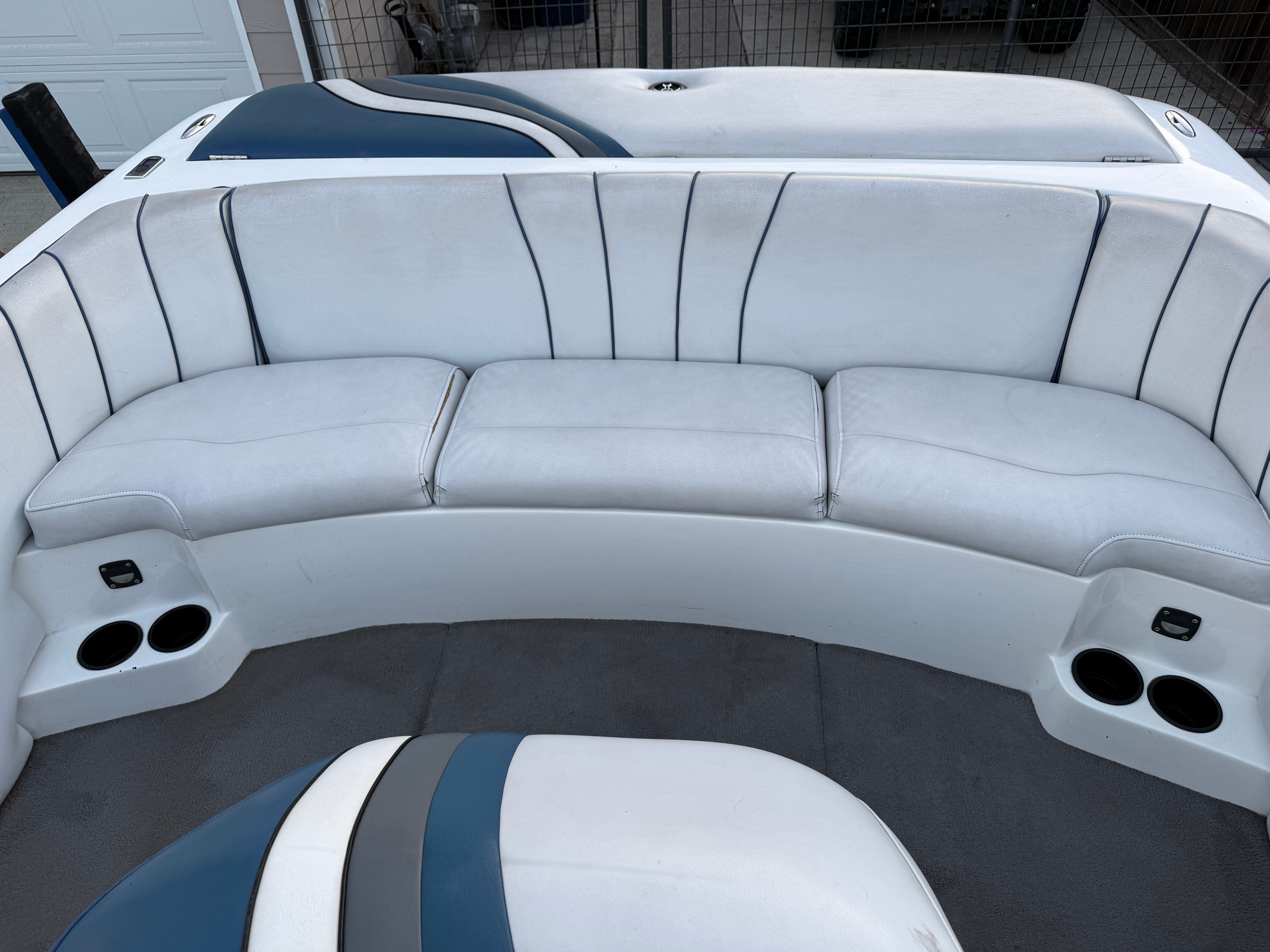 Interior of a 2004 MB Sports 220 boat with white seating.