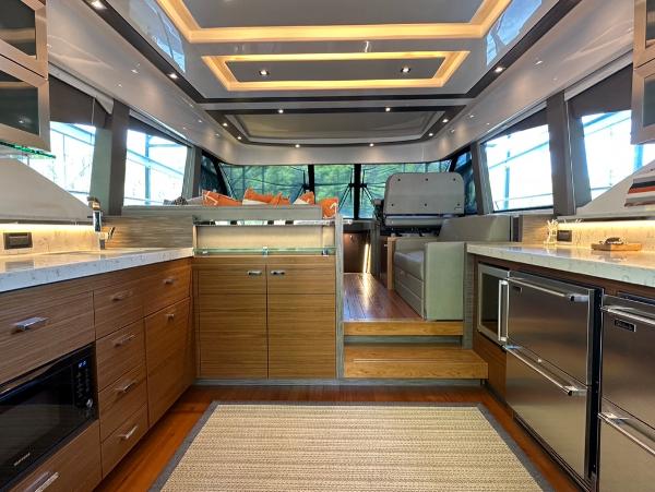 Luxurious interior of 2019 Tiara Yachts C53 with modern kitchen and seating area.