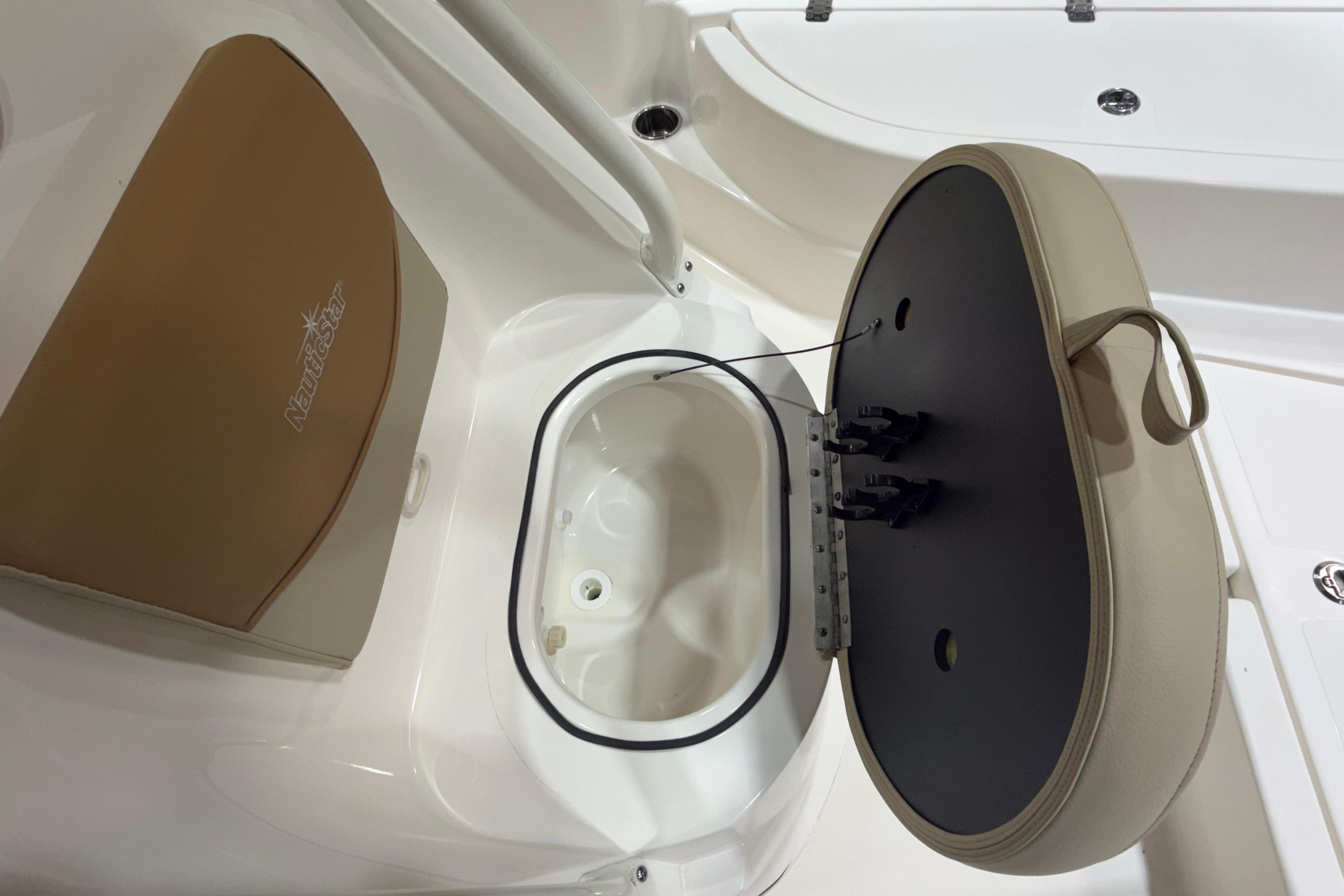2023 NauticStar 215 XTS boat seat with storage compartment open.