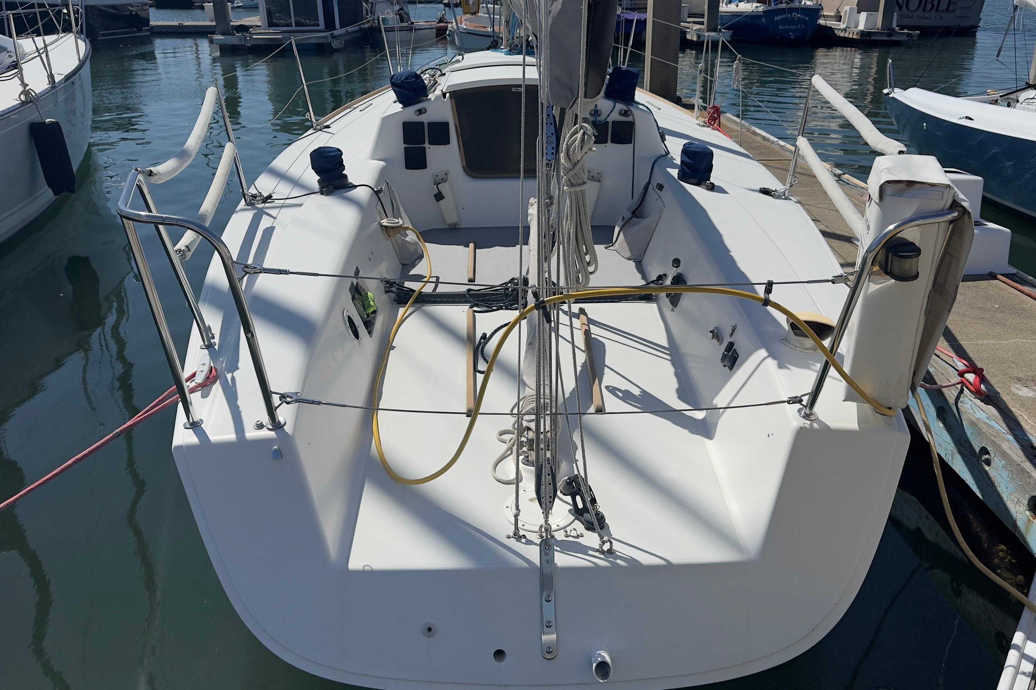 1994 J Boats J/92 sailboat docked at marina, showcasing spacious cockpit and sleek design.