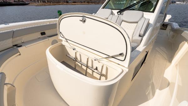 2025 Scout 425 LXF boat interior with open storage compartment, showcasing luxury seating and design.