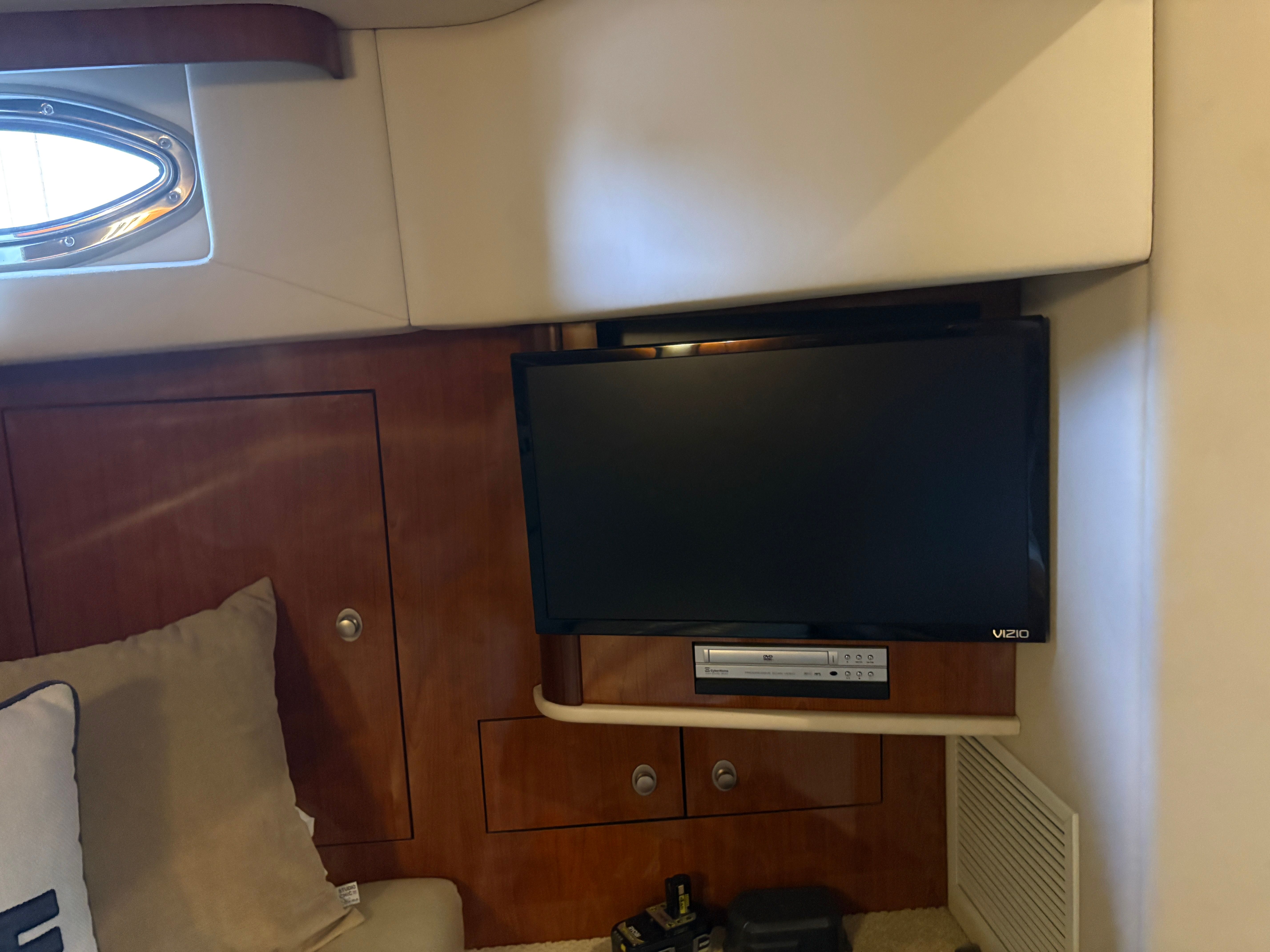 Interior of a 2005 Sea Ray 420 Sundancer with TV and wood paneling.