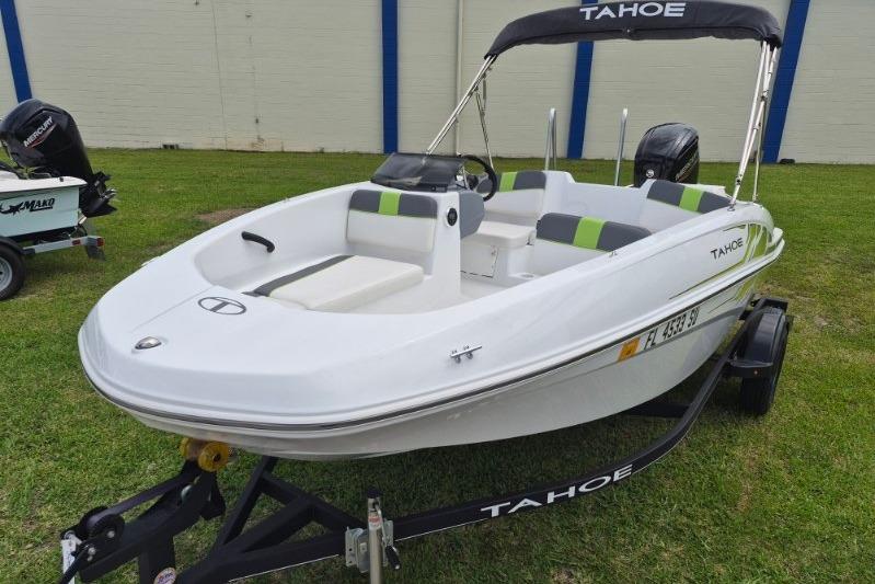 2021 Tahoe T16 boat on trailer, white with green accents, parked on grass.