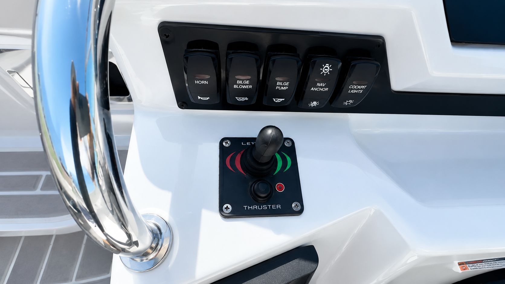 Close-up of the helm console with joystick and switches.