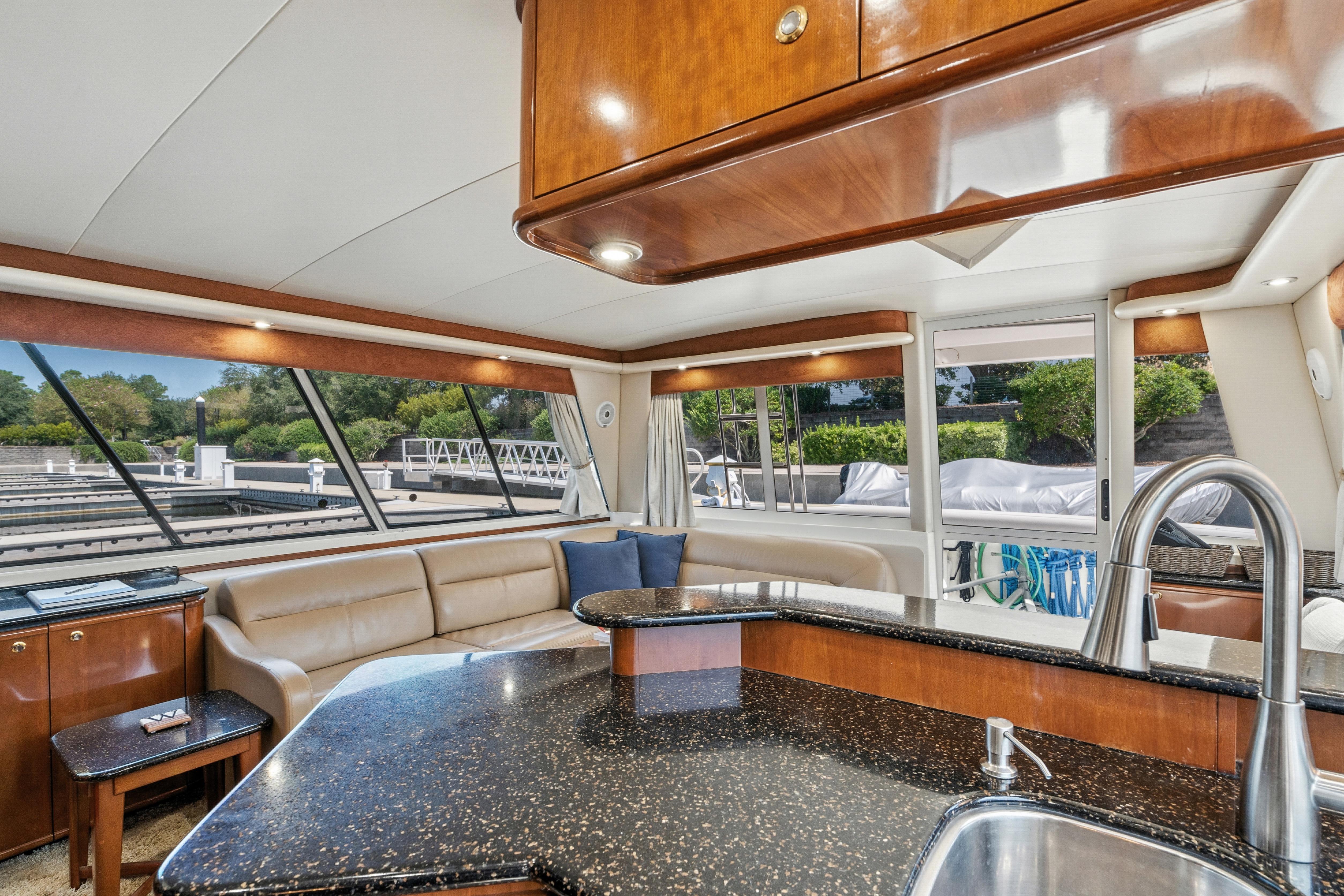 Luxurious interior of 2007 Meridian 490 Pilothouse yacht with modern kitchen and seating area.