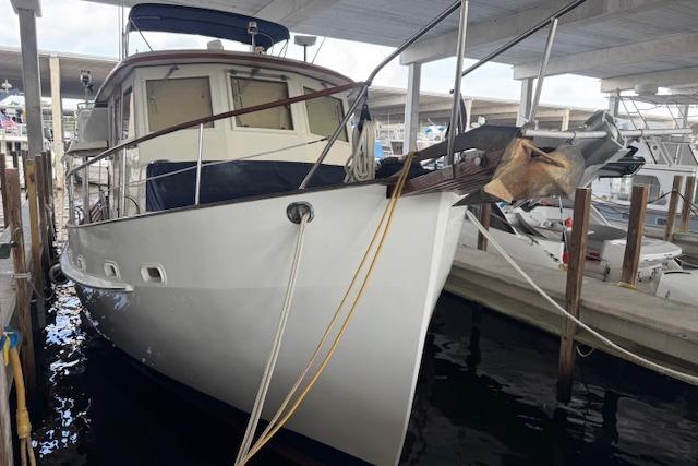 1986 Krogen 42 Classic yacht docked in a marina under a covered slip.