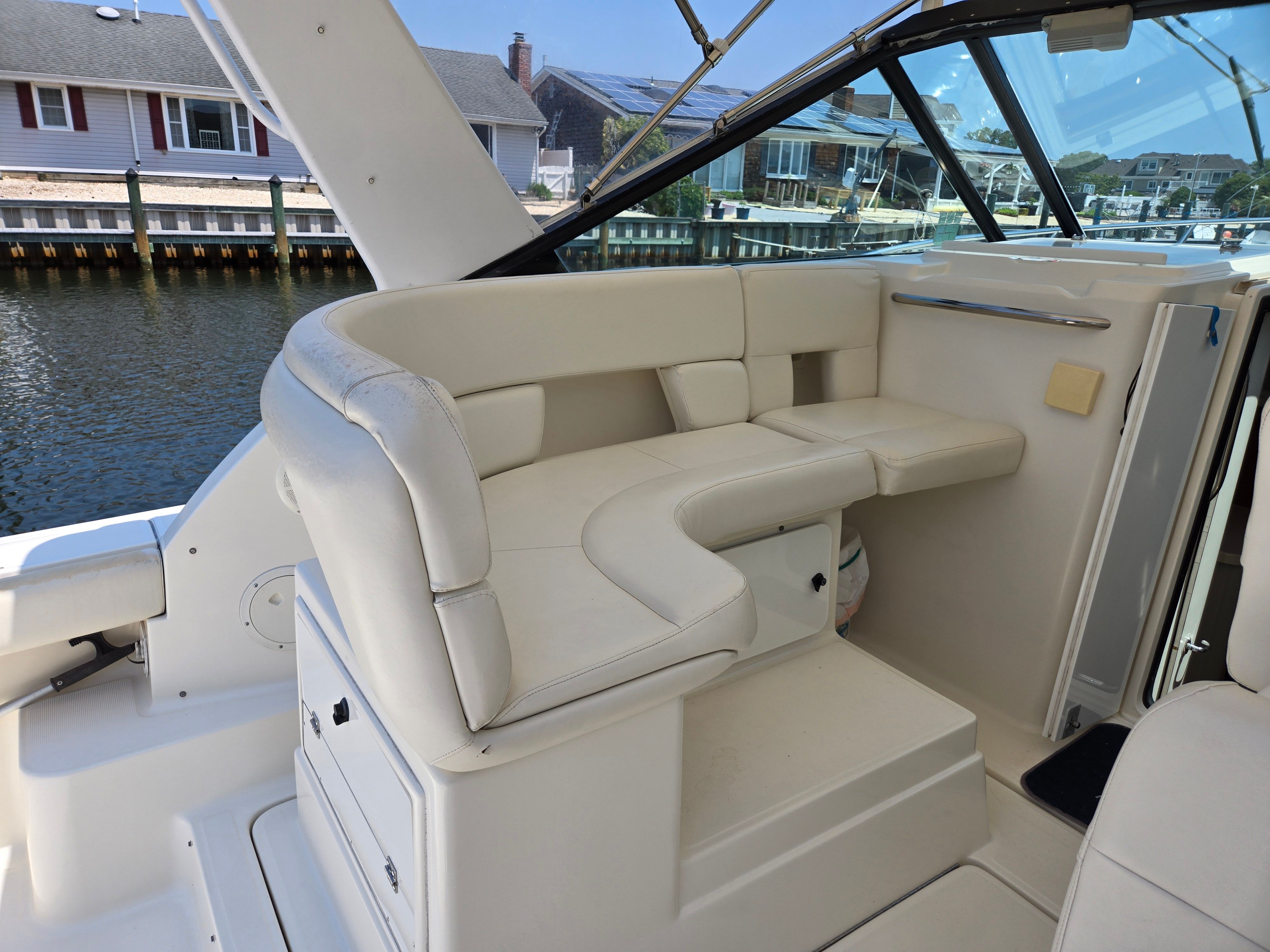 The image shows the seating area of a 1997 Tiara Yachts Open with beige upholstery.