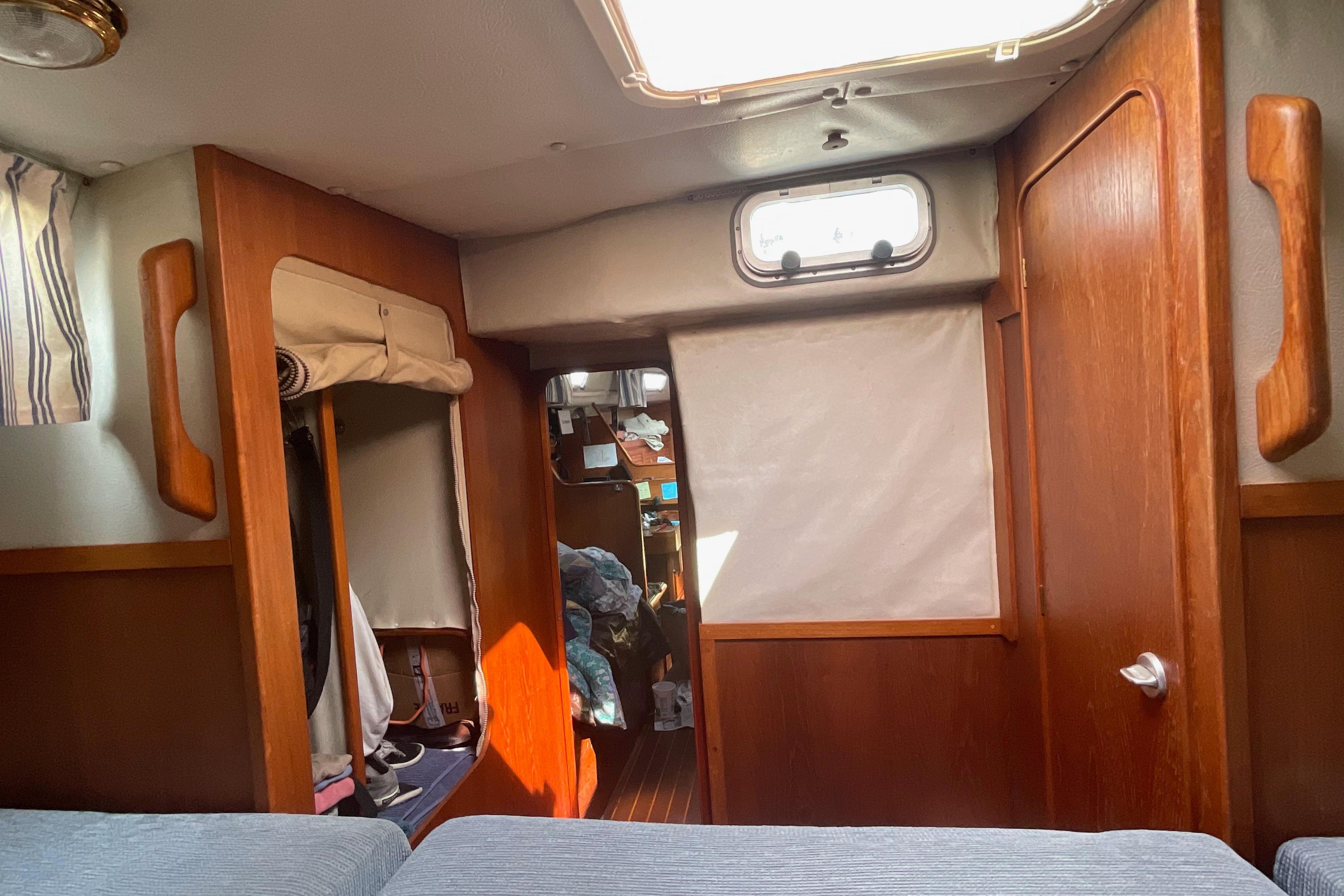 Interior of 1988 Westerly Corsair 36 sailboat, featuring wooden cabinetry and cozy living space.
