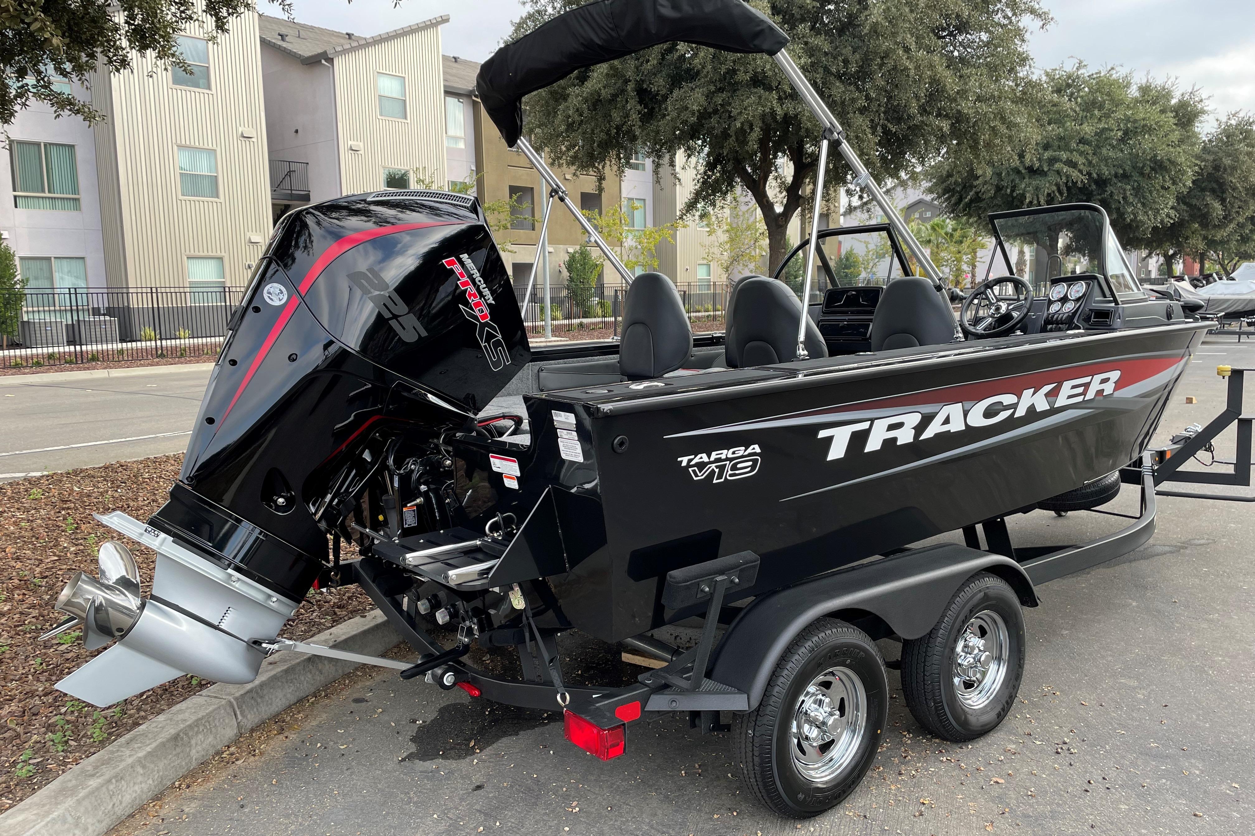 2026 Tracker Targa V-19 WT boat on trailer, parked outdoors.