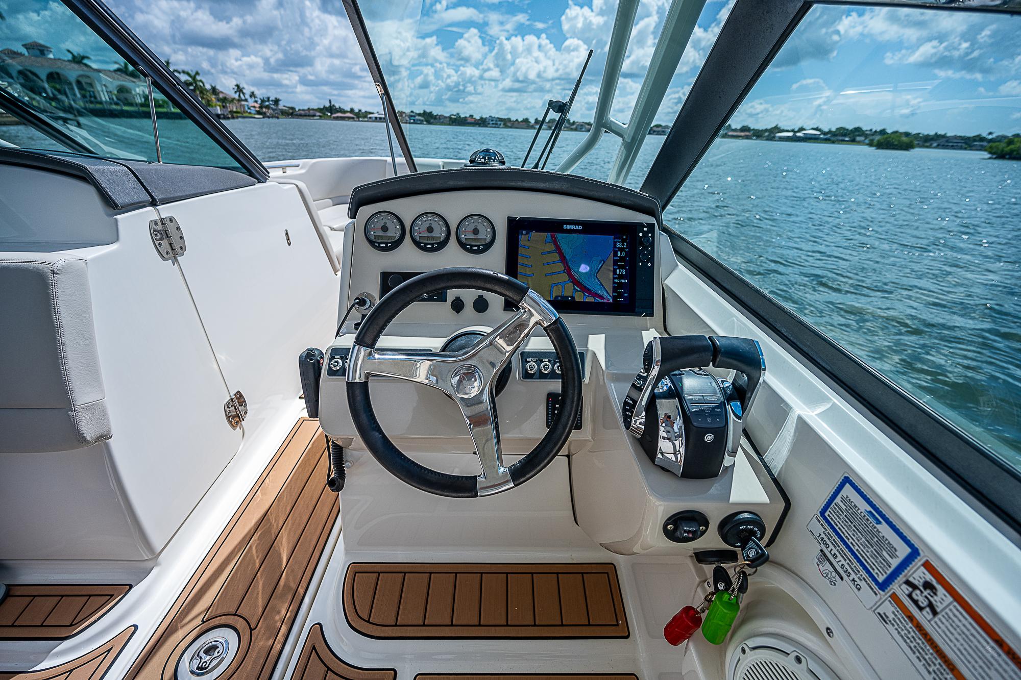 2018 Boston Whaler 270 Vantage boat cockpit with steering wheel and navigation system.