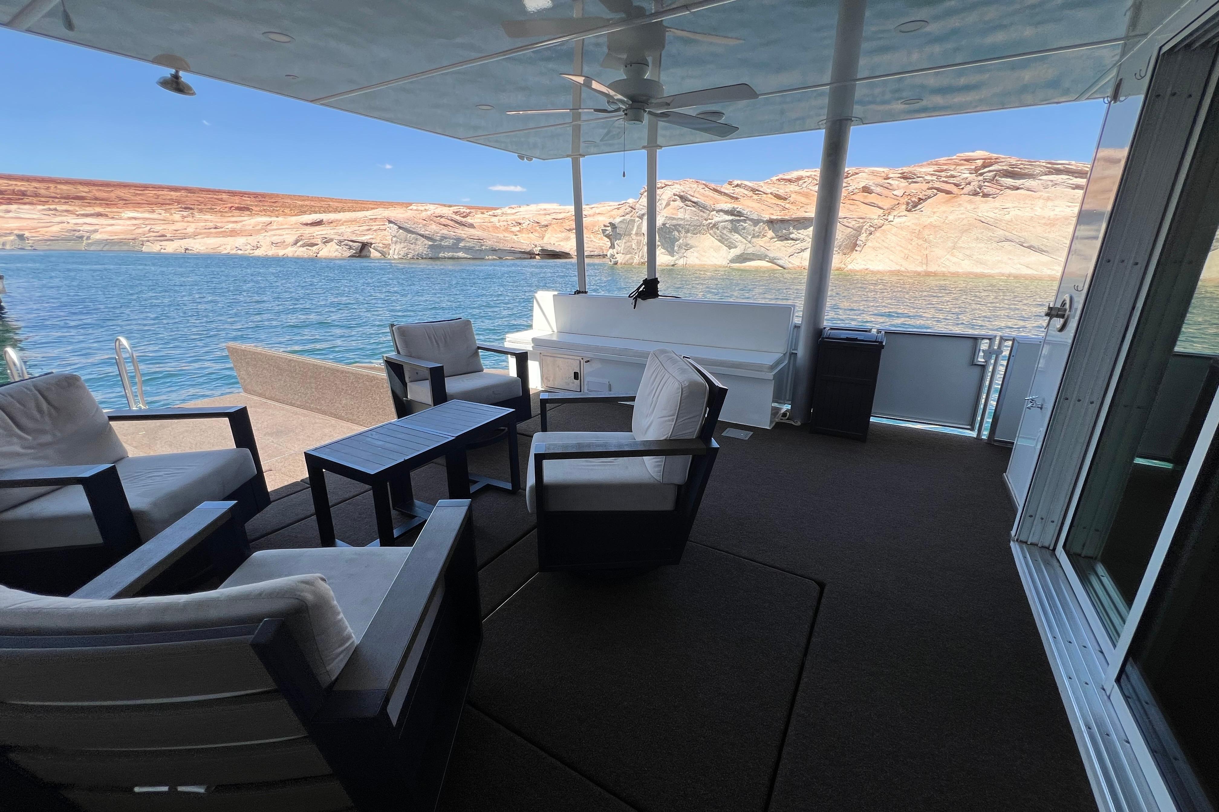 Luxurious Sumerset Excellence Multiple Shares 2025 houseboat deck with stunning lake and cliff views.