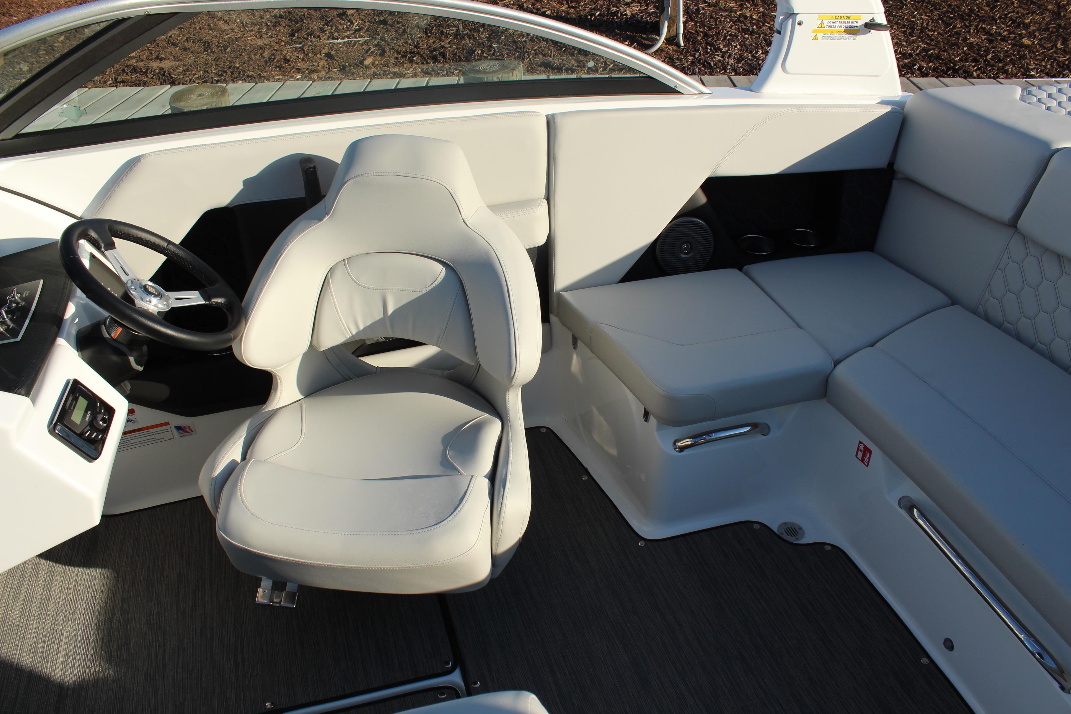 2026 Four Winns H2 Freedom boat interior with sleek seating and modern steering wheel.