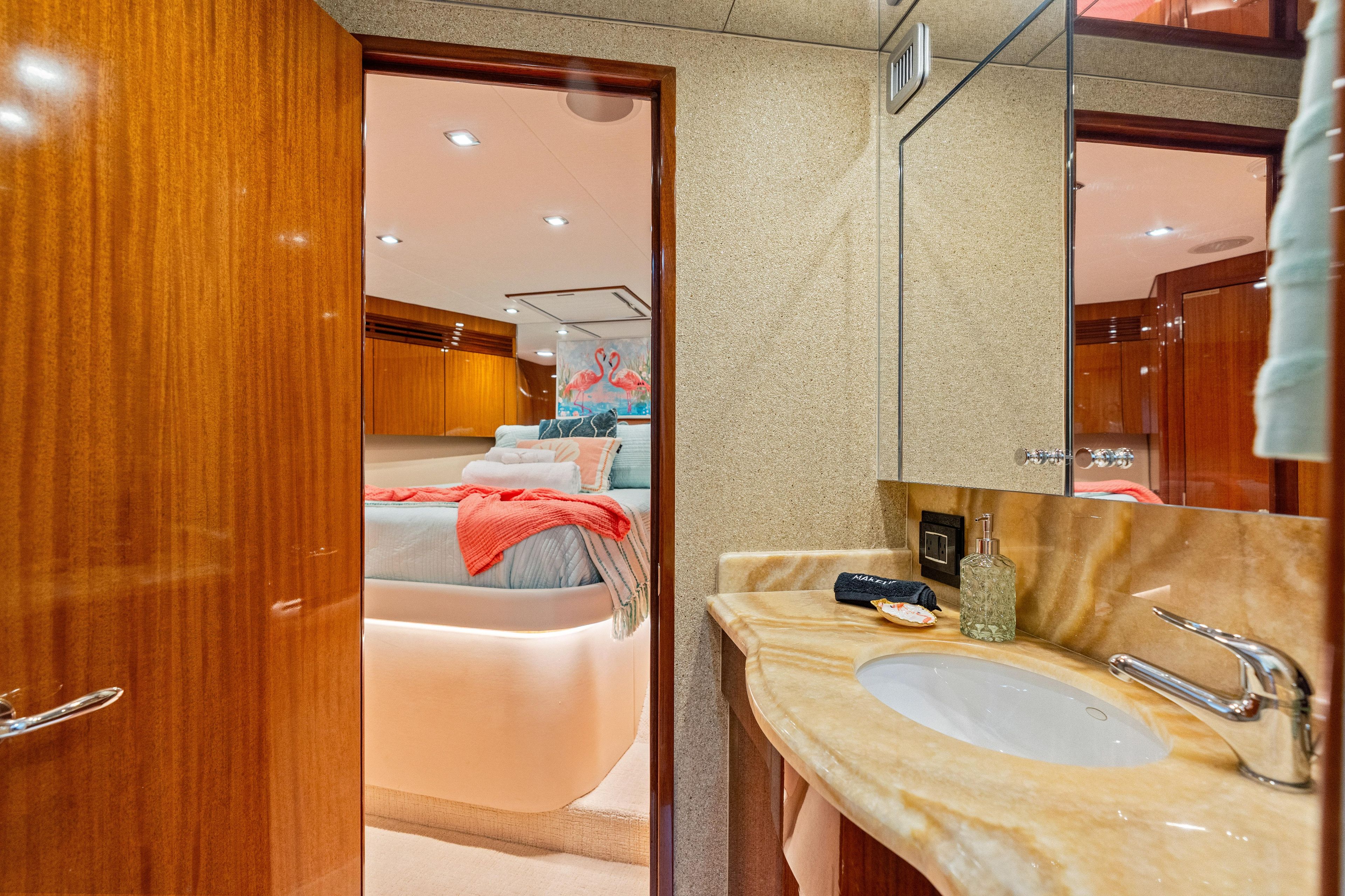 Luxurious 2008 Hatteras 64 Motor Yacht interior with elegant bedroom and bathroom design.