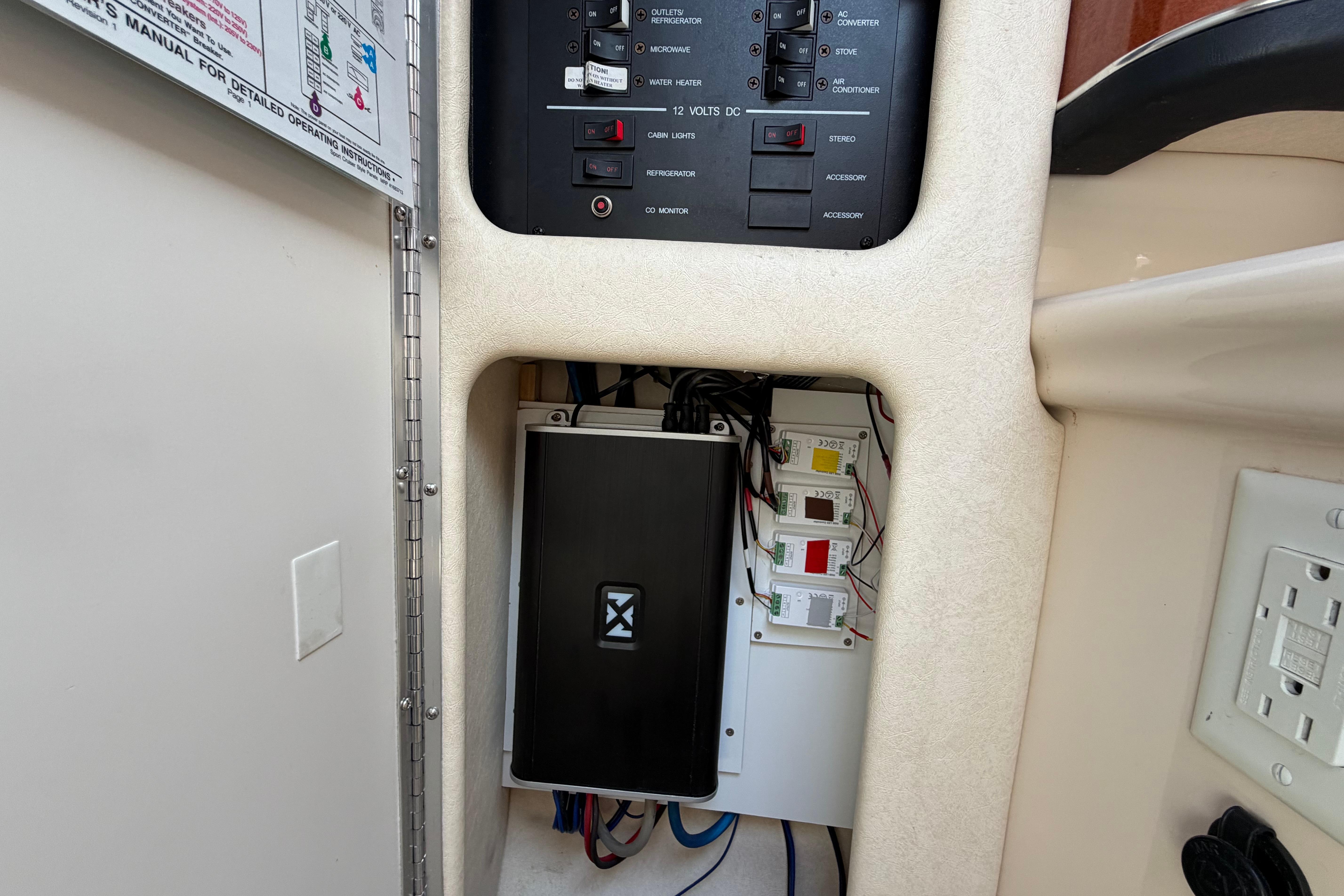 Electrical panel inside a 2004 Sea Ray Sundancer 260 boat, showcasing wiring and controls.