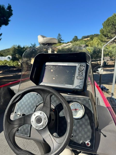 The image shows the cockpit of a 2020 Bass Tracker Tracker Pro Classic with a steering wheel and screen.