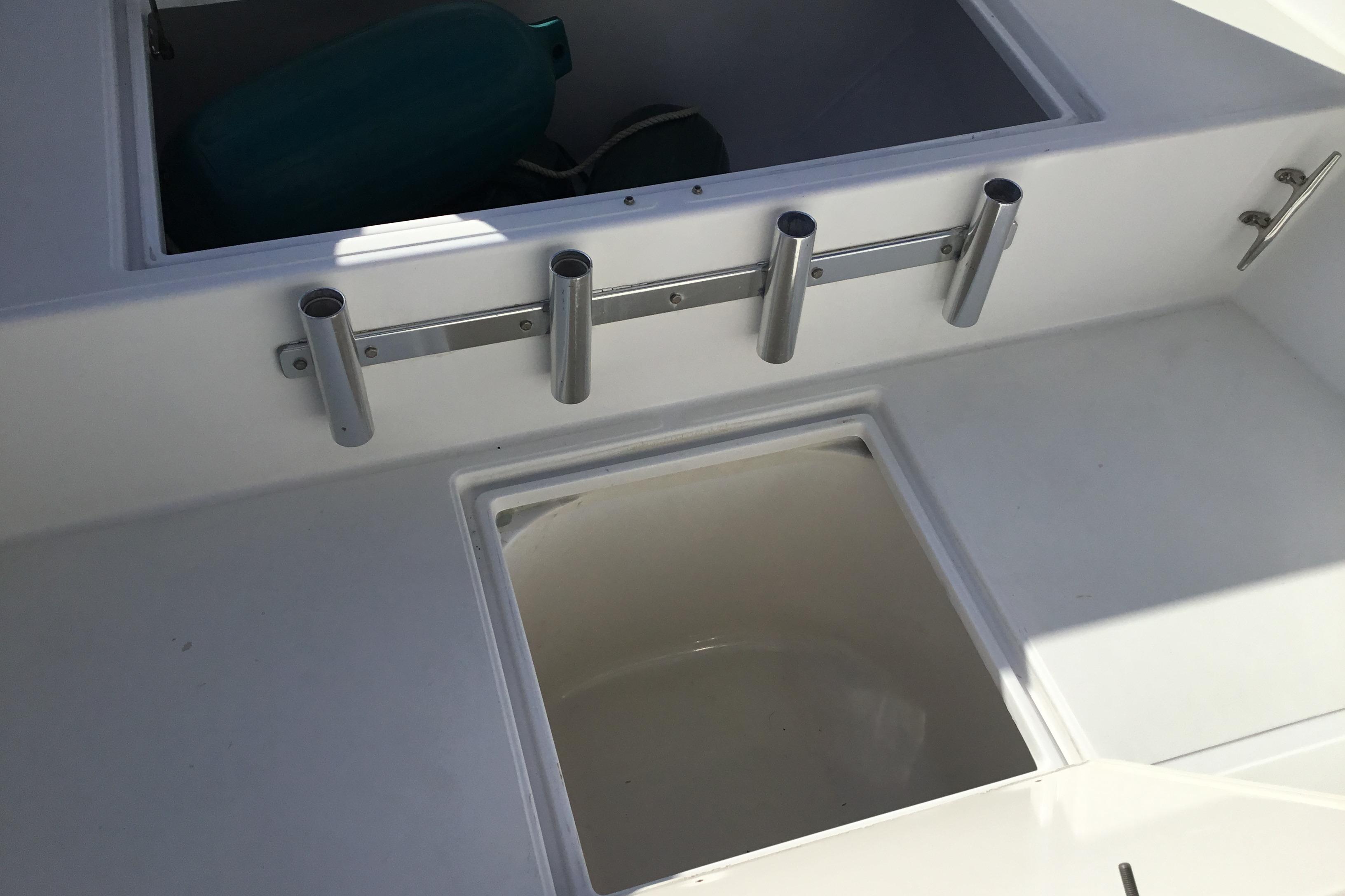 2000 Jupiter 31 Center Console boat interior with rod holders and storage compartments.