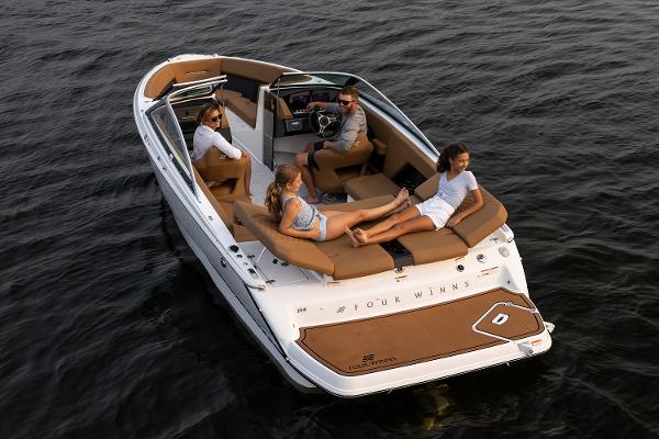 Manufacturer Provided Image: 2025 Four Winns H4 boat with passengers relaxing on water.