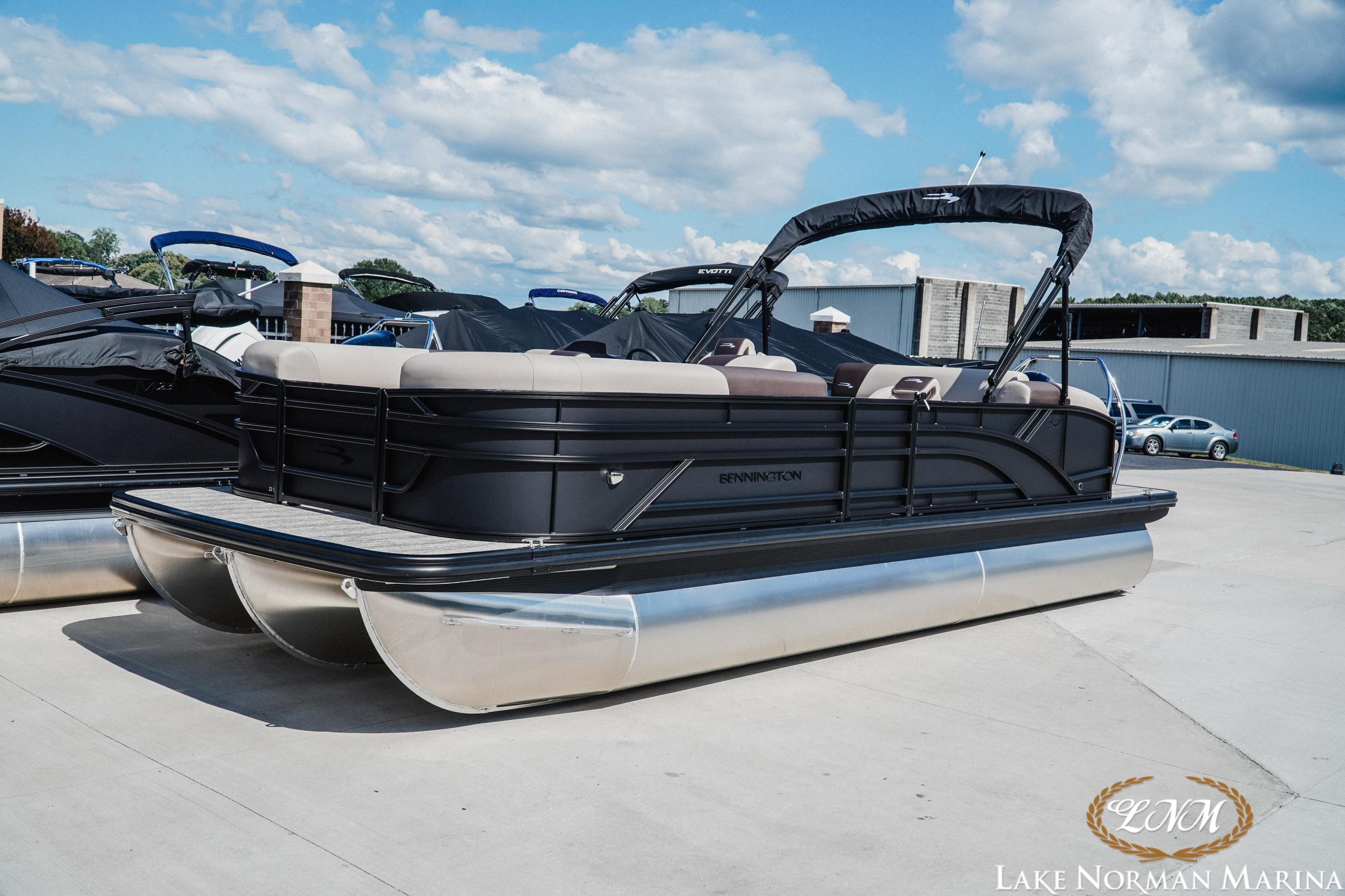 2027 Bennington 23SSB pontoon boat at Lake Norman Marina under a blue sky.