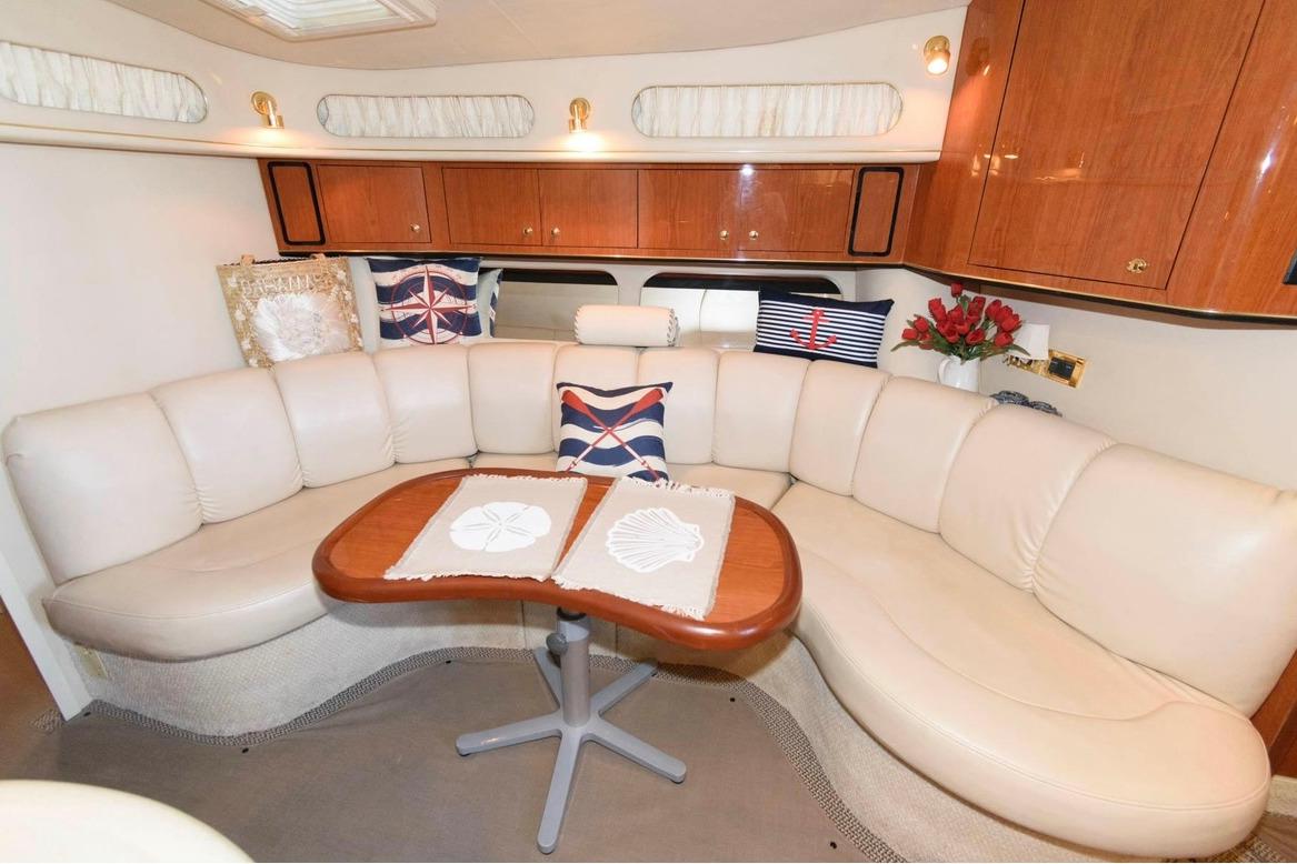 Luxurious interior of 1999 Sea Ray Sundancer 400 yacht with plush seating and elegant decor.