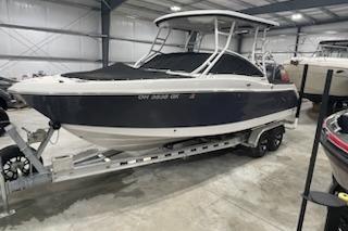2022 Robalo R247 Dual Console boat on trailer in indoor storage facility.