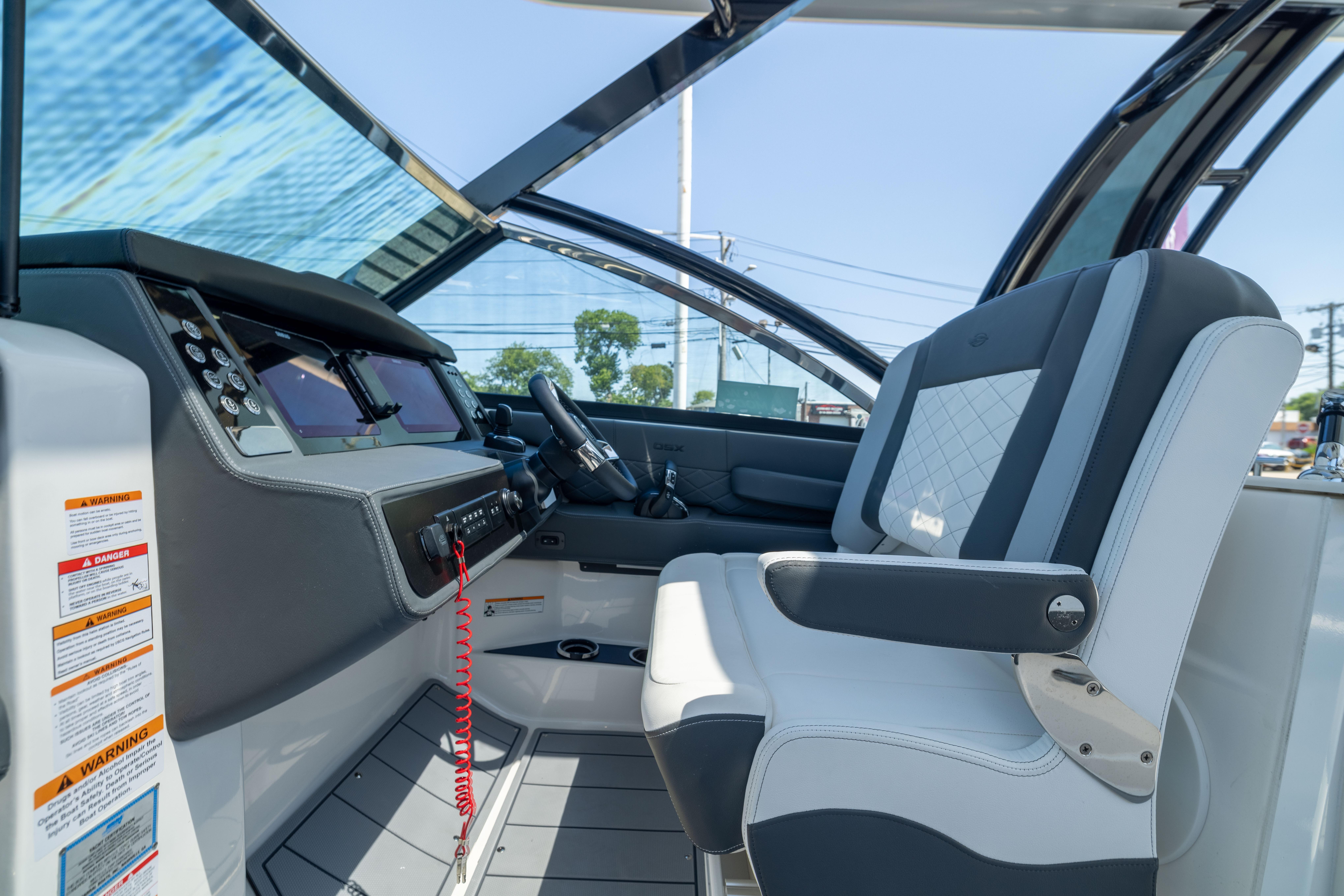 2026 Chaparral 310 OSX boat interior with modern helm and luxurious seating.