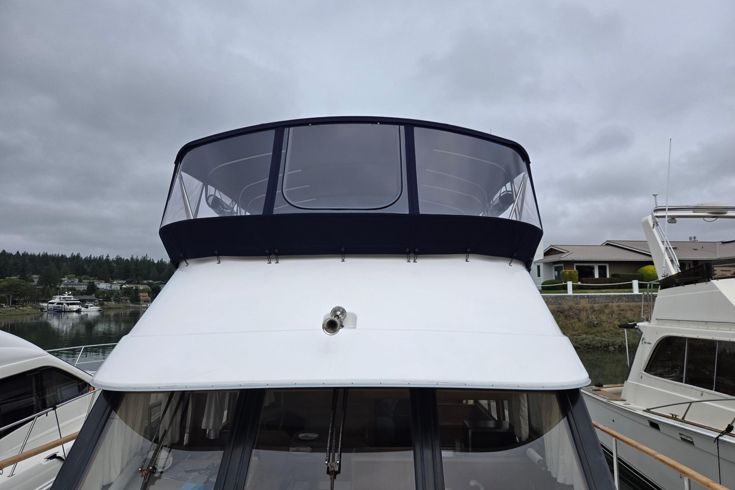 1993 Ocean Alexander 423 Classicco yacht docked under cloudy skies.