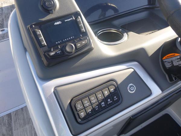 2024 Ranger Reata 223C boat dashboard with control panel and cup holder.