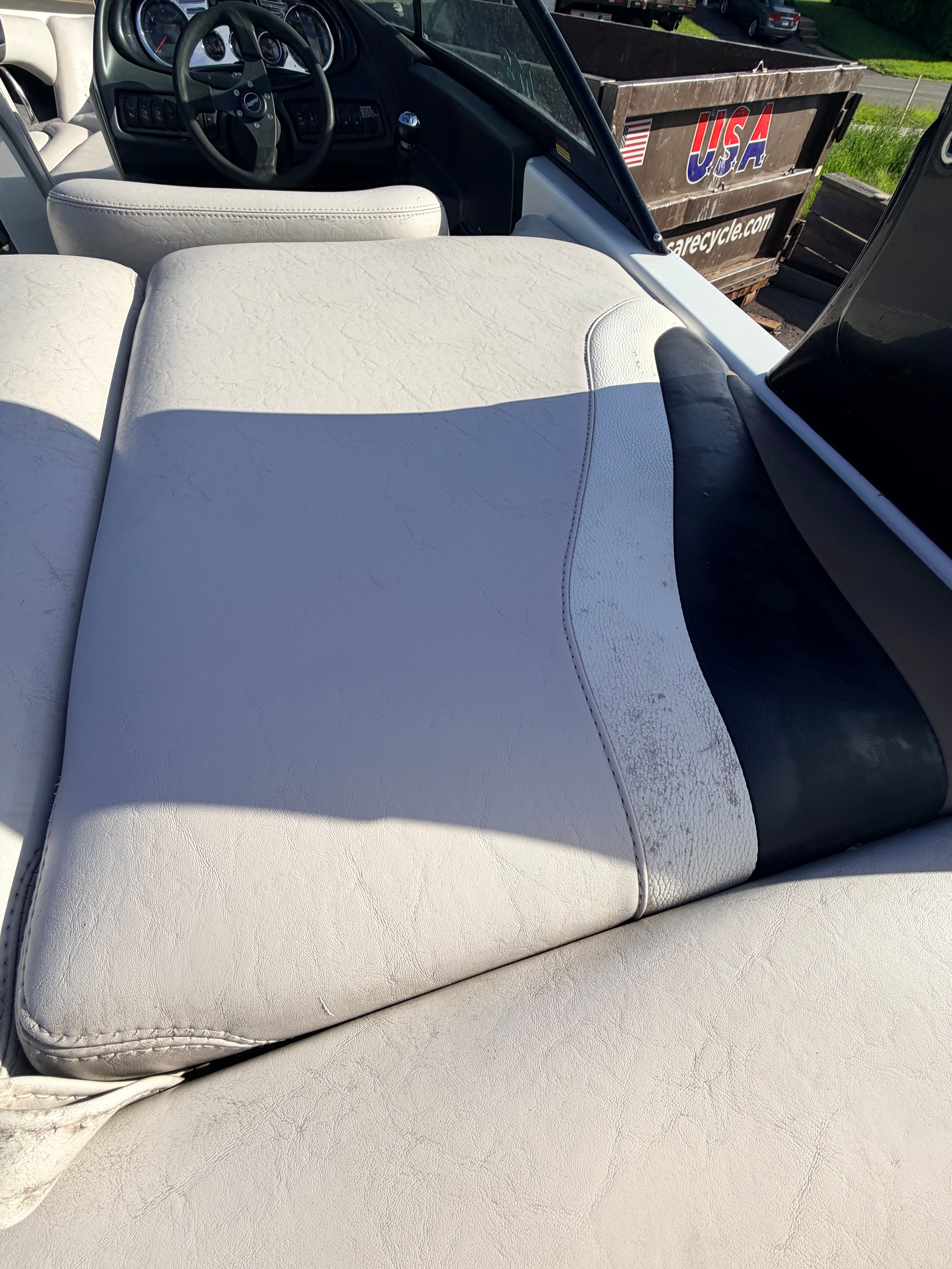 Interior of a 2006 Malibu iRide boat with white leather seats.