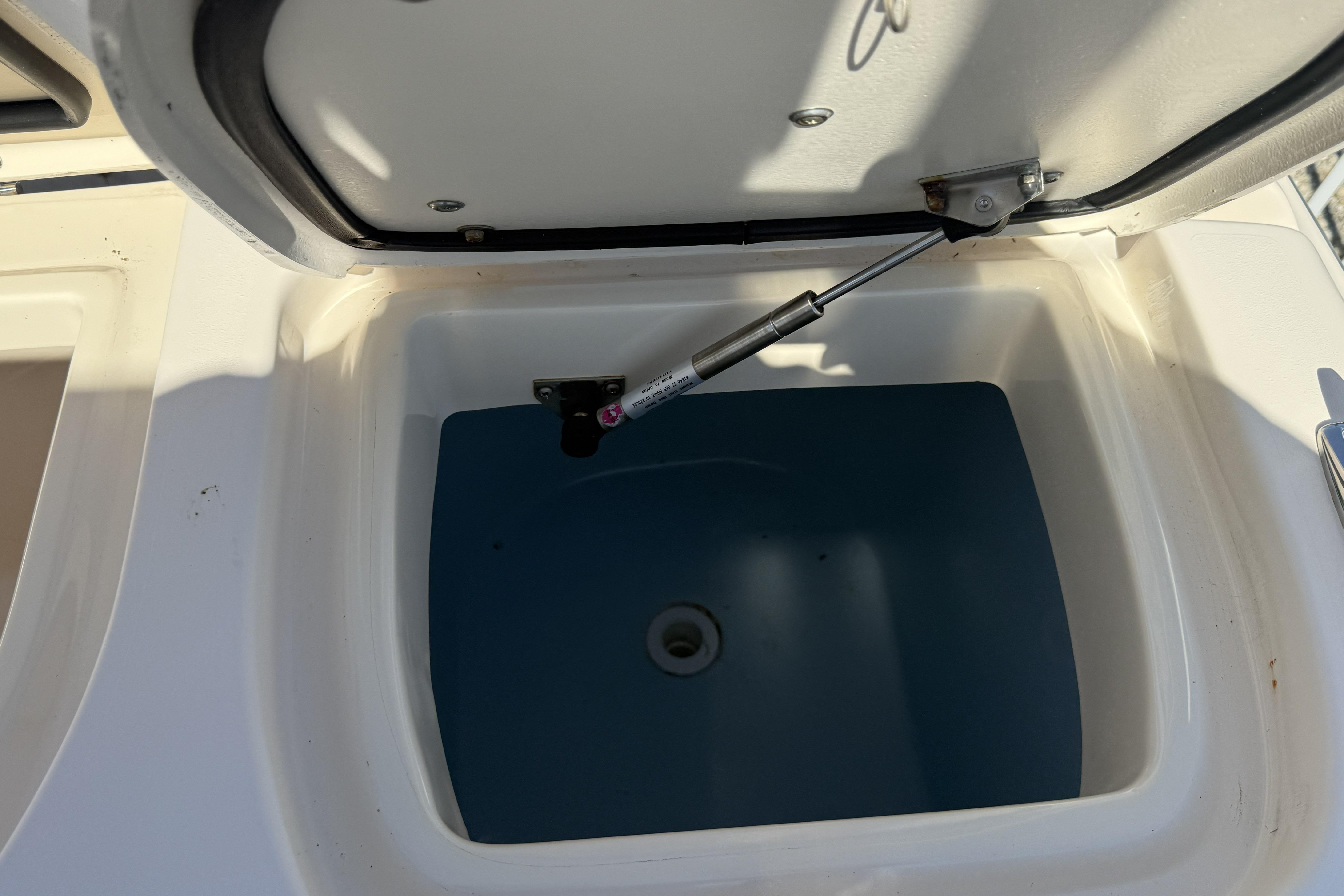 Open storage compartment on 2014 Grady-White Freedom 275 boat, showing interior details.