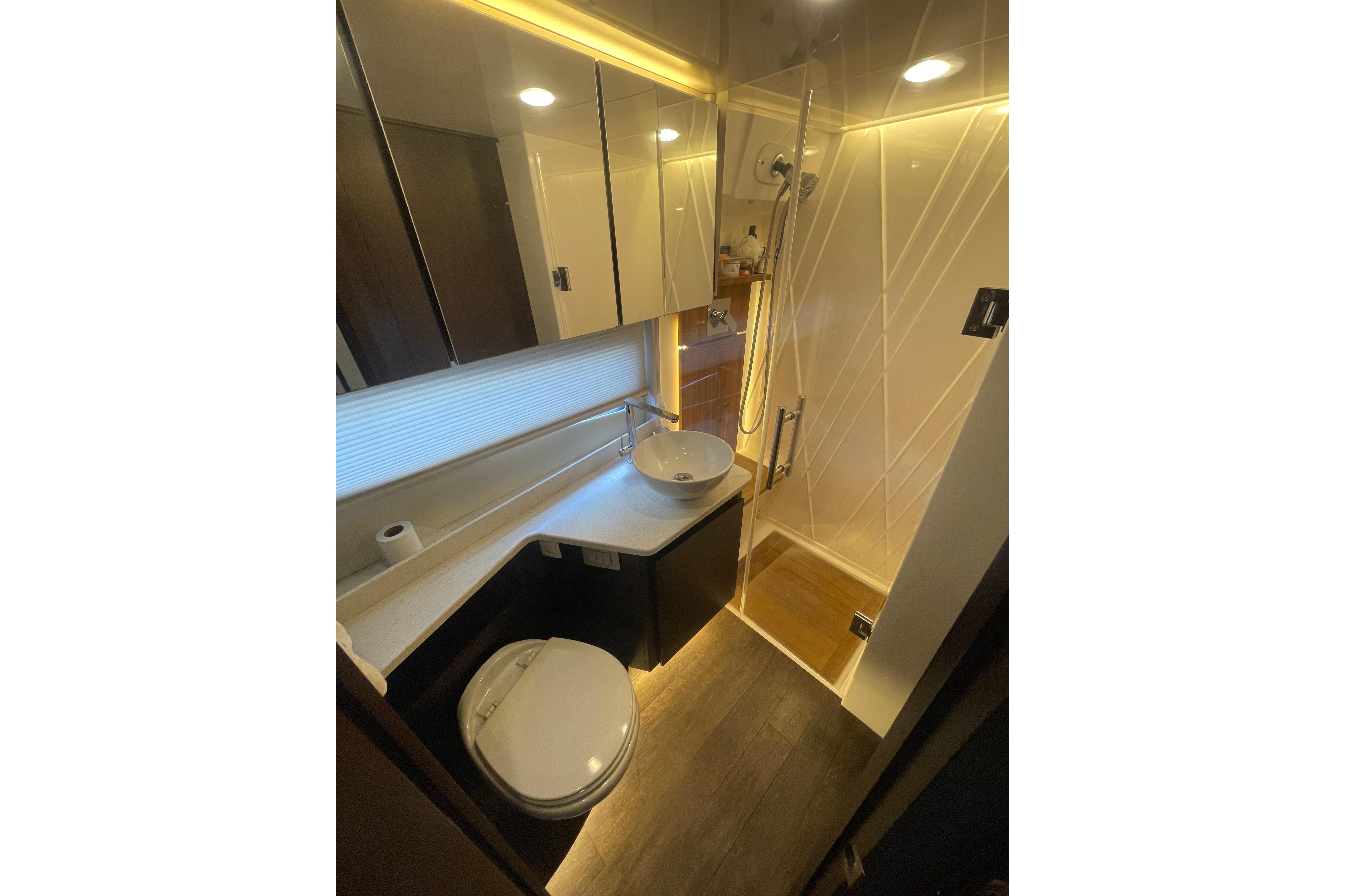 Luxurious bathroom in 2020 Regal 42 Grande Coupe yacht with modern fixtures and ambient lighting.