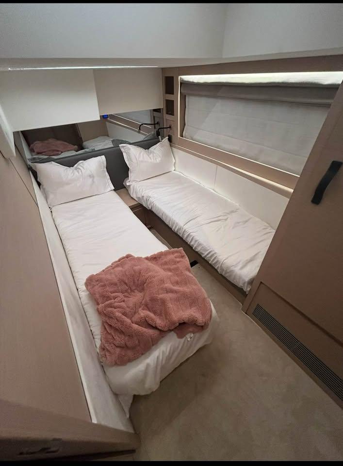 2023 Prestige 520S yacht cabin with twin beds and cozy decor.