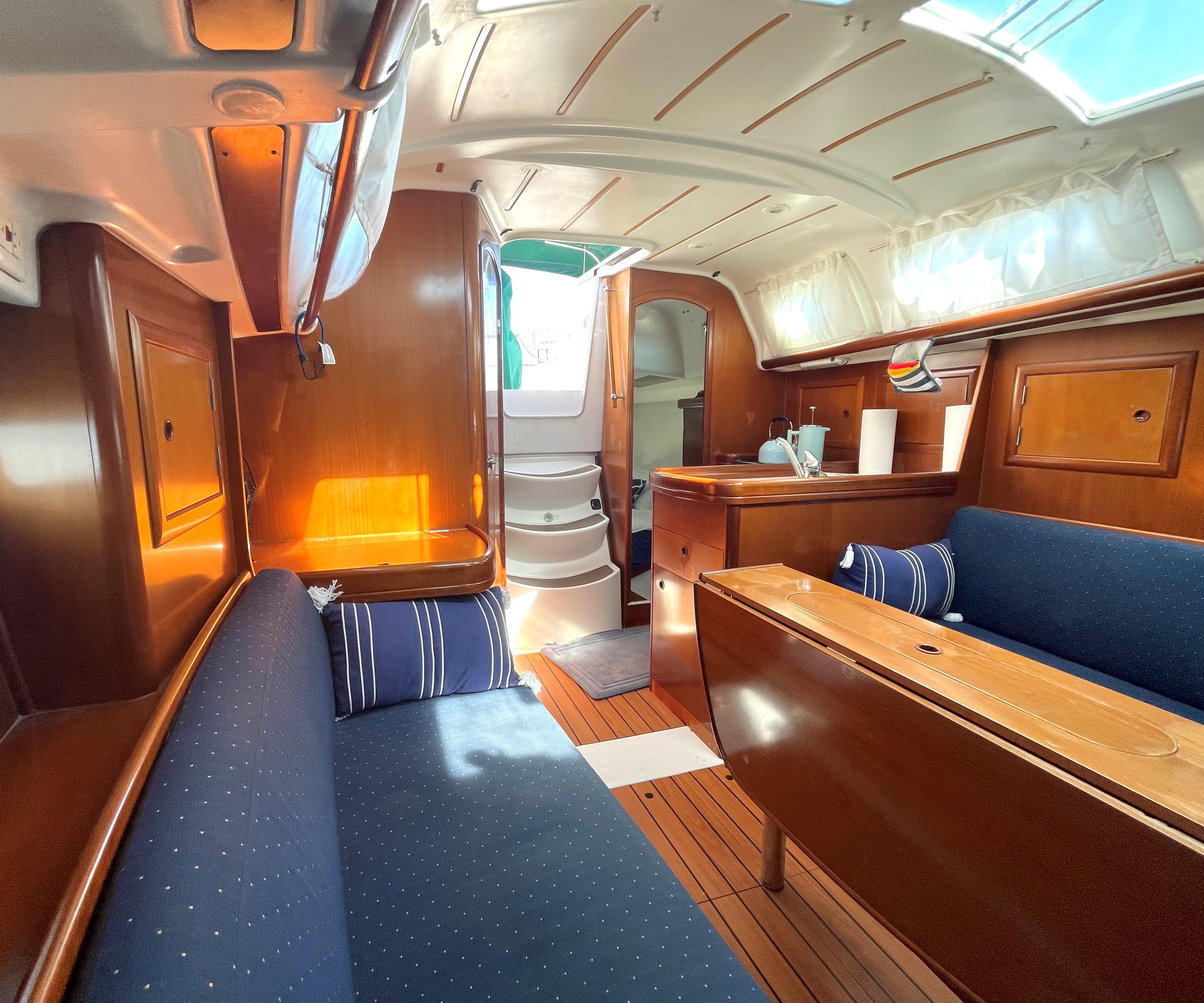 Interior of a 2005 Beneteau 323 yacht with wooden furnishings.