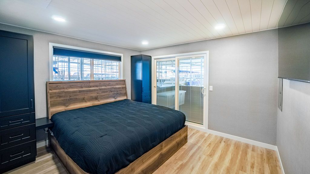 Bedroom in Sumerset Widebody houseboat, modern design, wooden flooring.