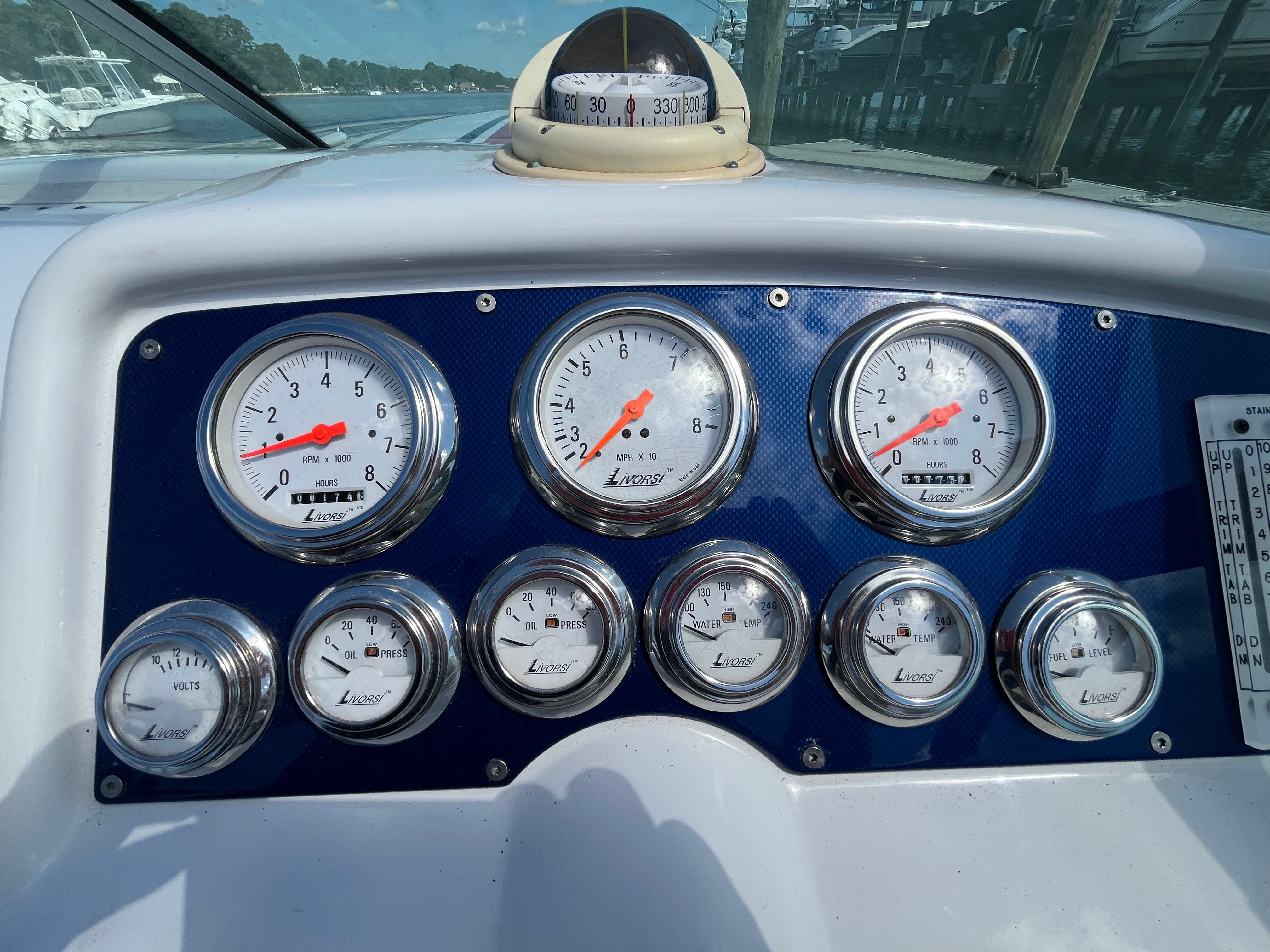 Dashboard of a 2004 Formula 292 FASTech with multiple gauges and a compass.