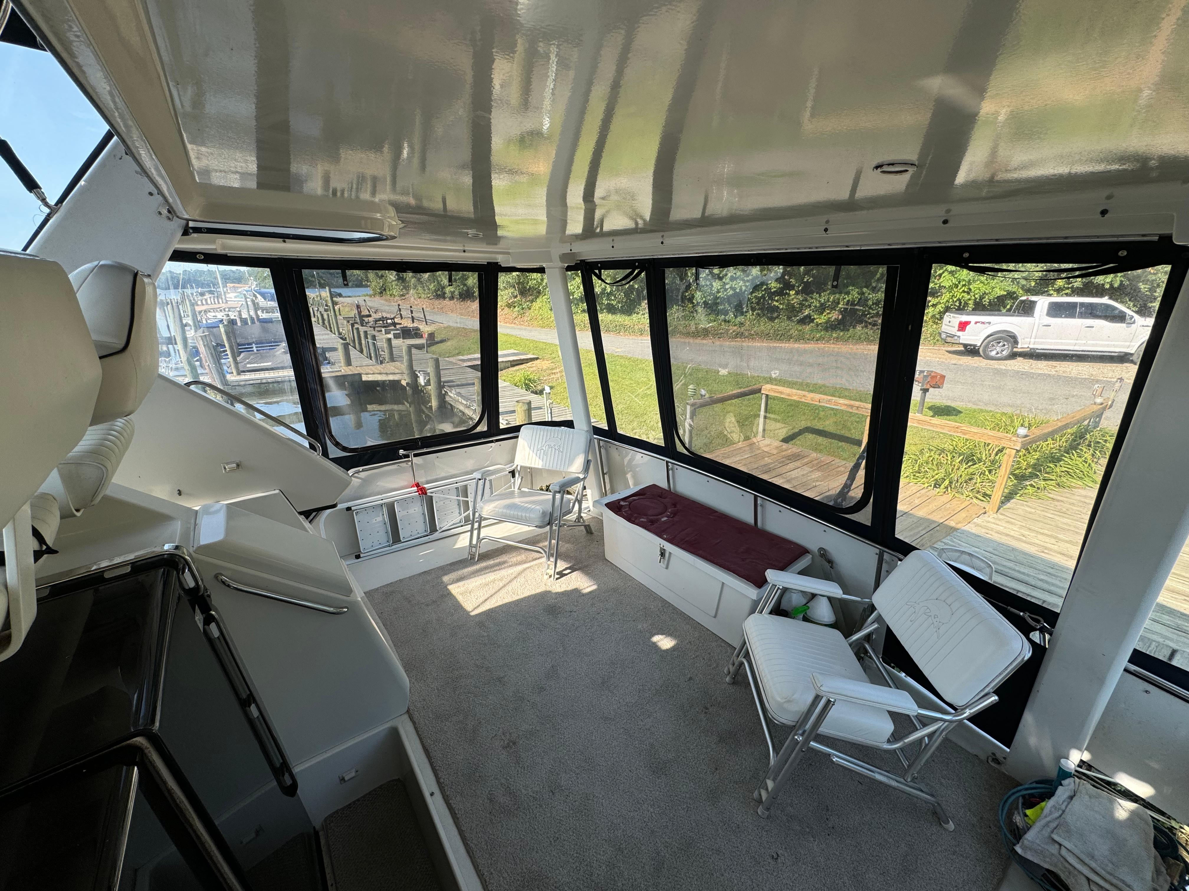 Interior of 1991 Carver 33 Aft Cabin with seating and large windows.