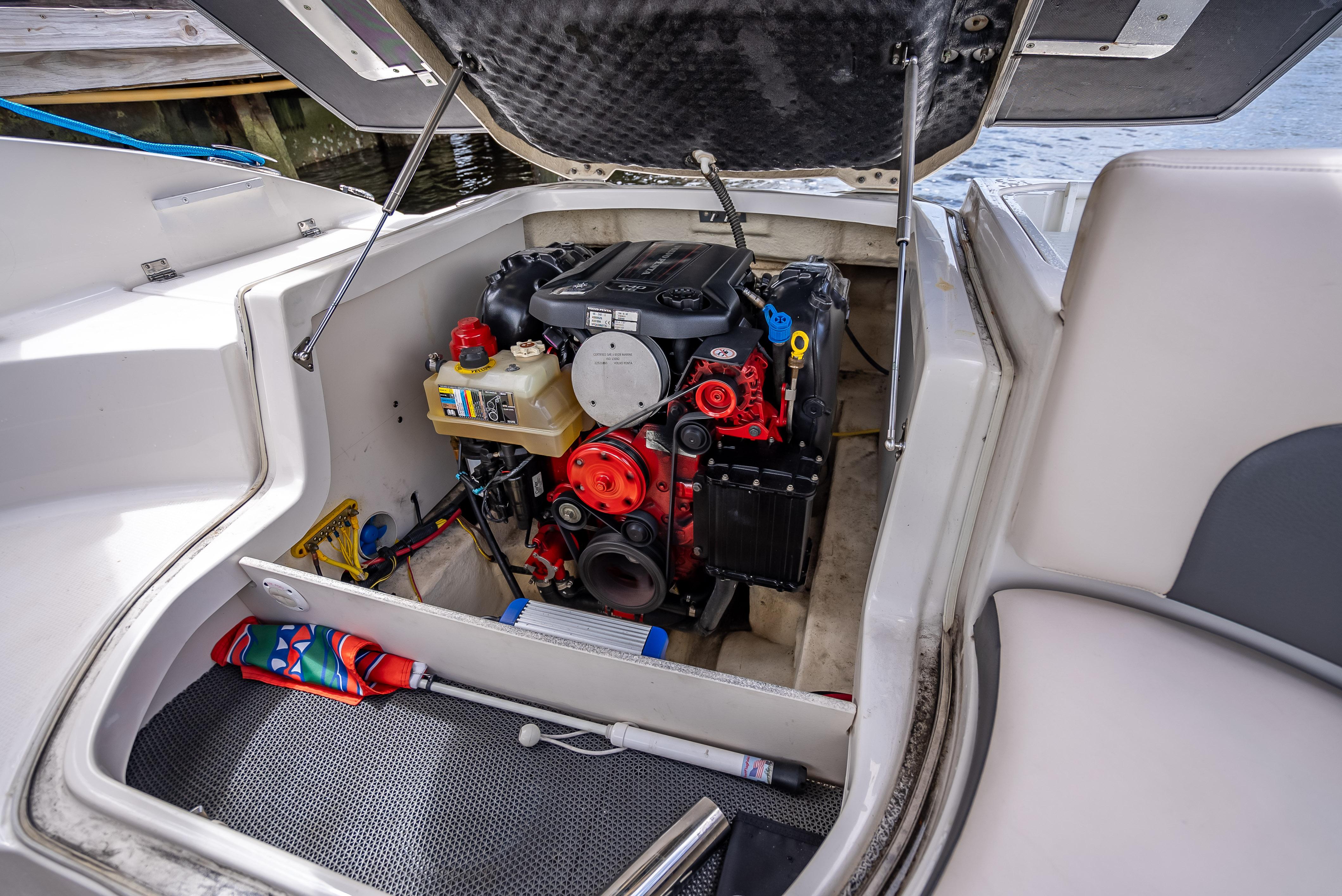 Engine compartment of a 2017 Chaparral 227 SSX boat, showcasing the engine and storage area.