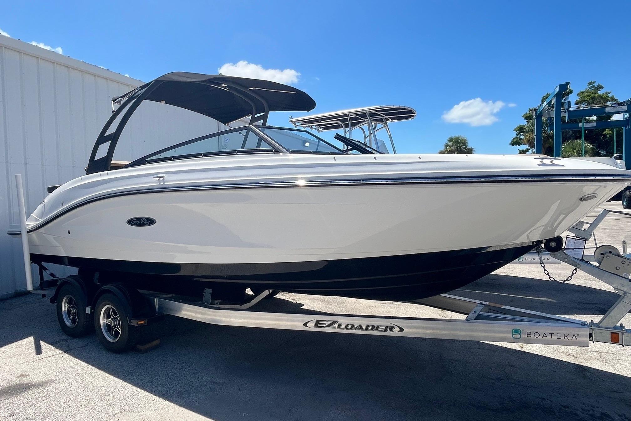 2024 Sea Ray SPX 230 boat on trailer, sleek design, white exterior, sunny day.