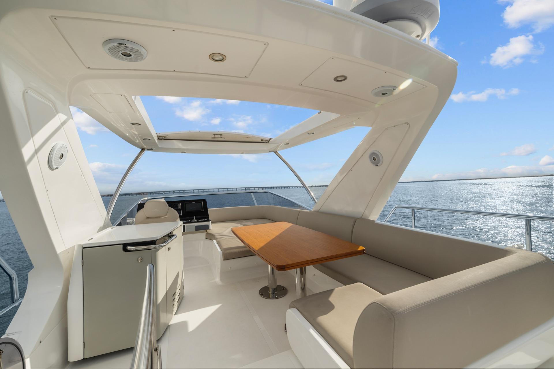 Luxurious 2019 Azimut 55 yacht deck with seating and ocean view.