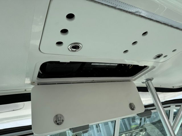 Close-up of a white boat ceiling with an opening and fittings.