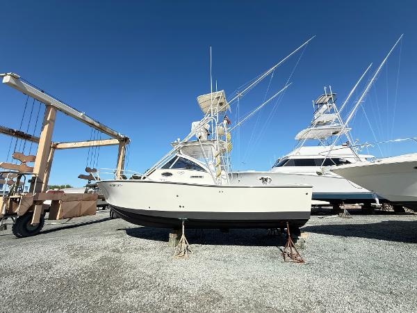 2001 Albemarle 280 Express Sport Fisherman boat on stands, clear sky background.