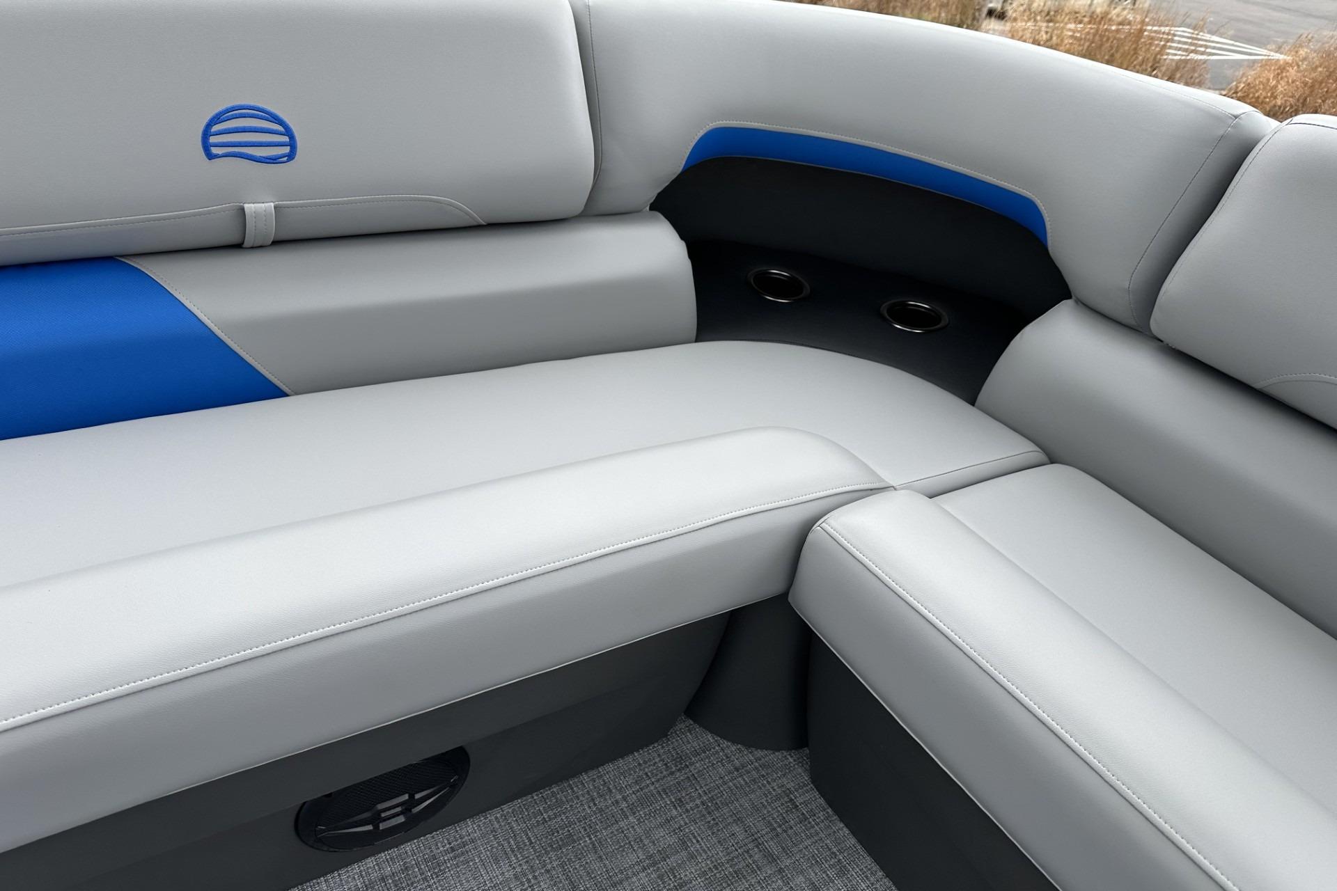 2026 Sun Tracker Party Barge 20 DLX interior with gray and blue seating.