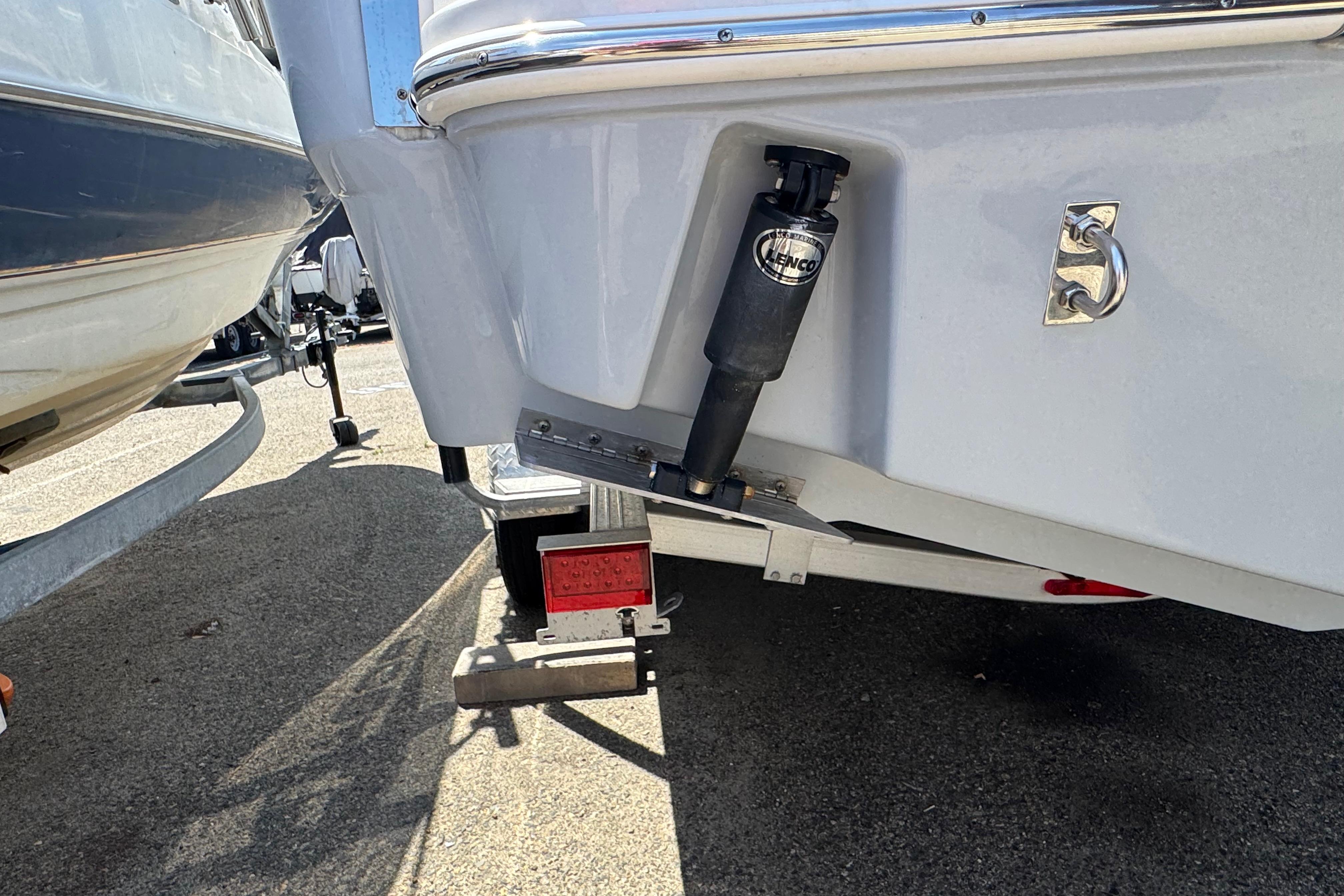 2022 Robalo R230 Center Console boat on trailer, showcasing rear trim tab mechanism.