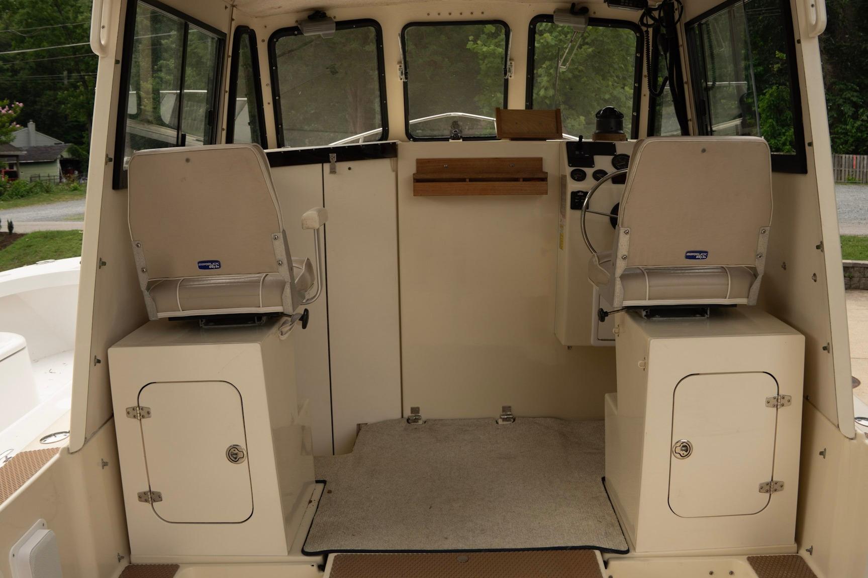 Interior of 2006 Atlas Boat Works Acadia 25, featuring helm and seating area.