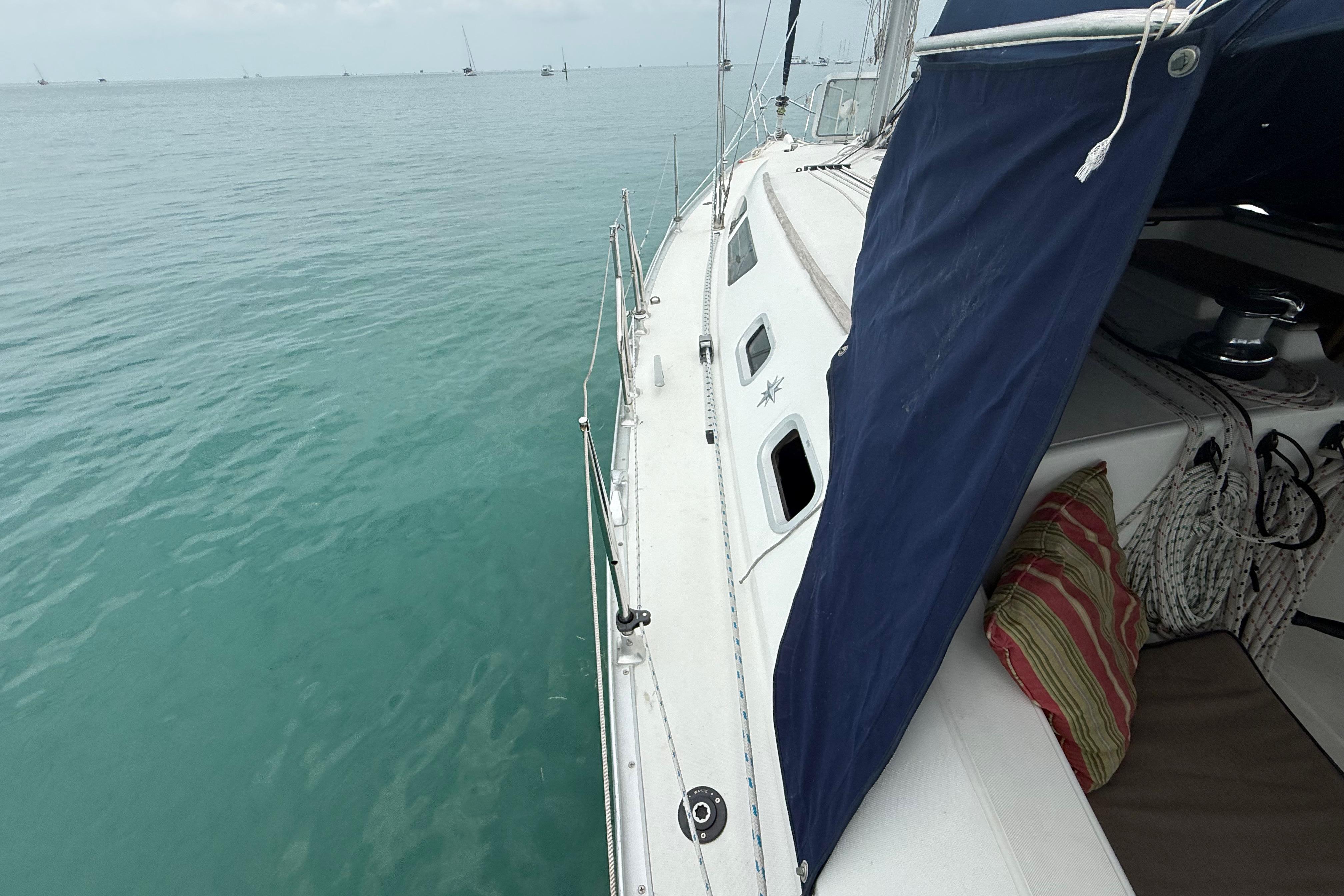 2003 Jeanneau Sun Odyssey 37 sailboat on calm blue water, featuring deck and cabin details.
