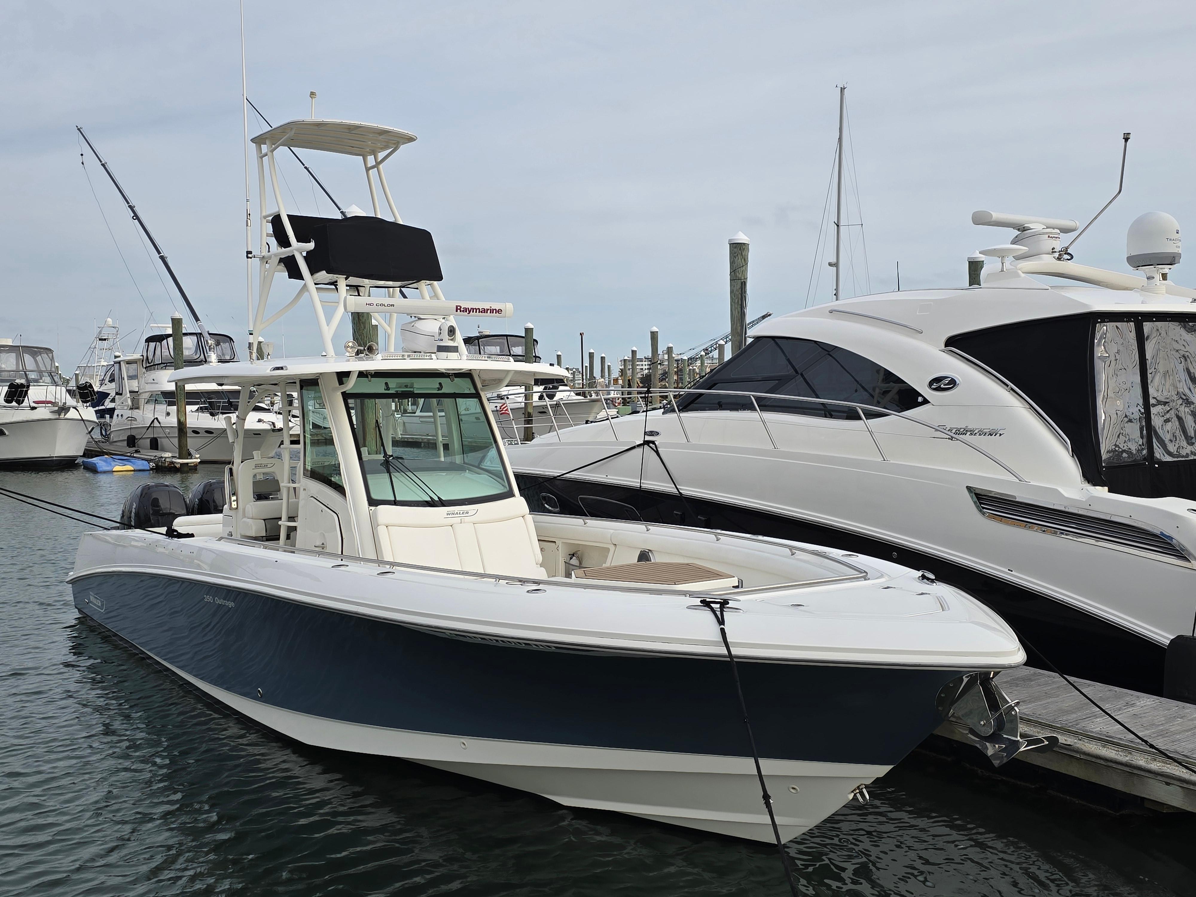 2015 Boston Whaler 350 Outrage boat docked at marina, side view.