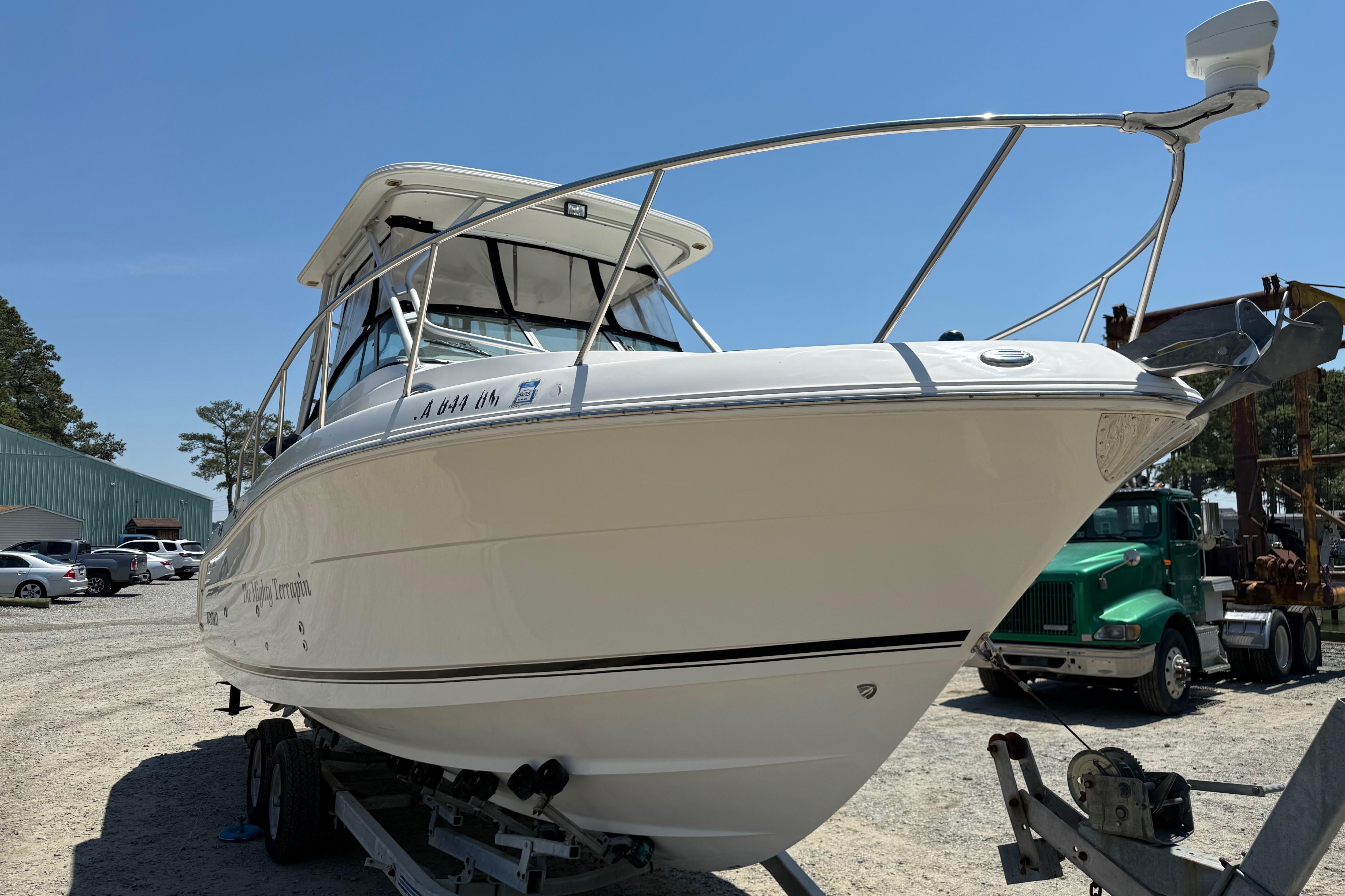 2007 Robalo R305 Walkaround boat on trailer in sunny outdoor setting.