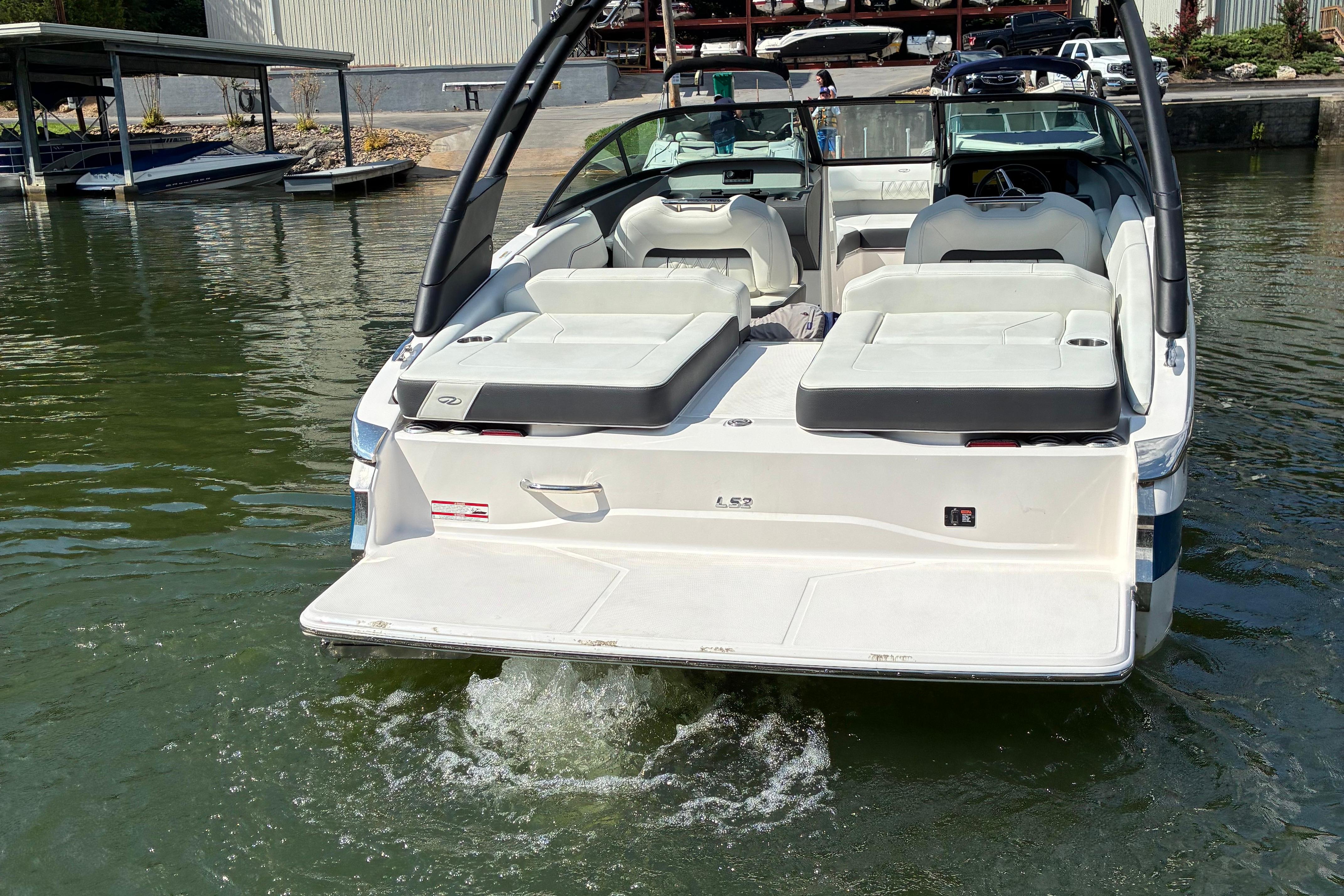 2025 Regal LS2 boat with spacious seating, docked on calm water.