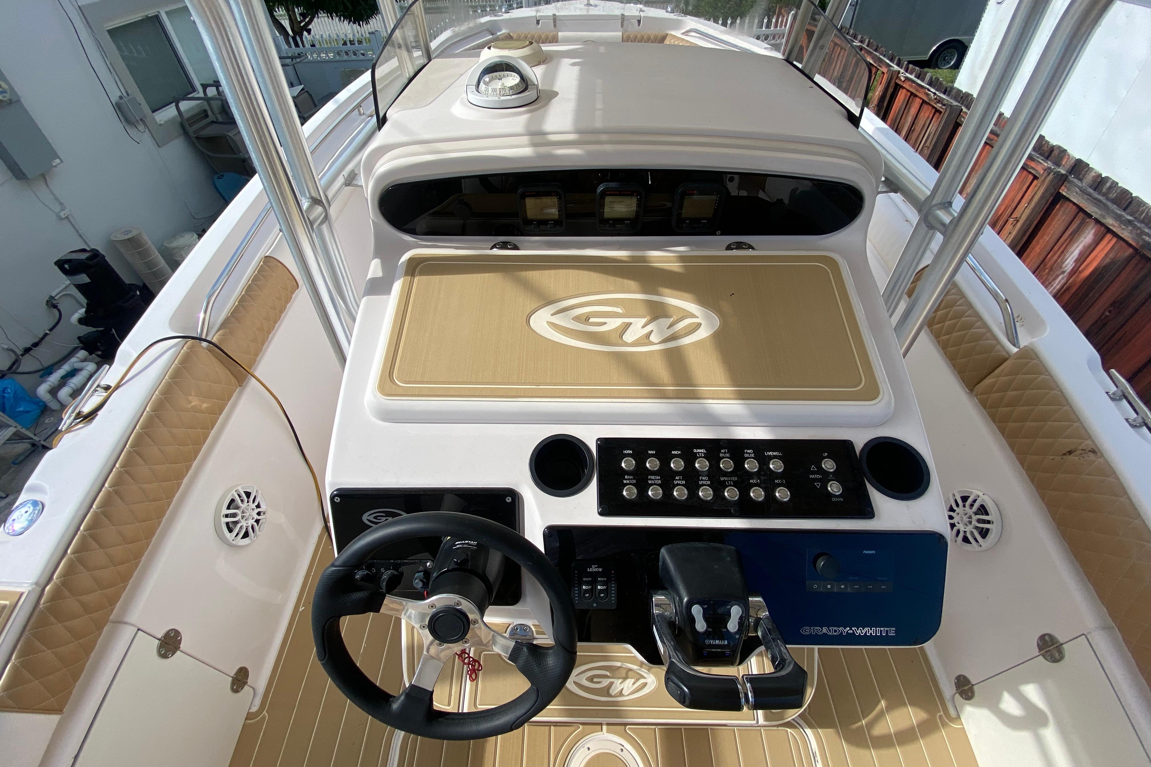 2004 Grady-White Canyon 283 boat dashboard with steering wheel and control panel.